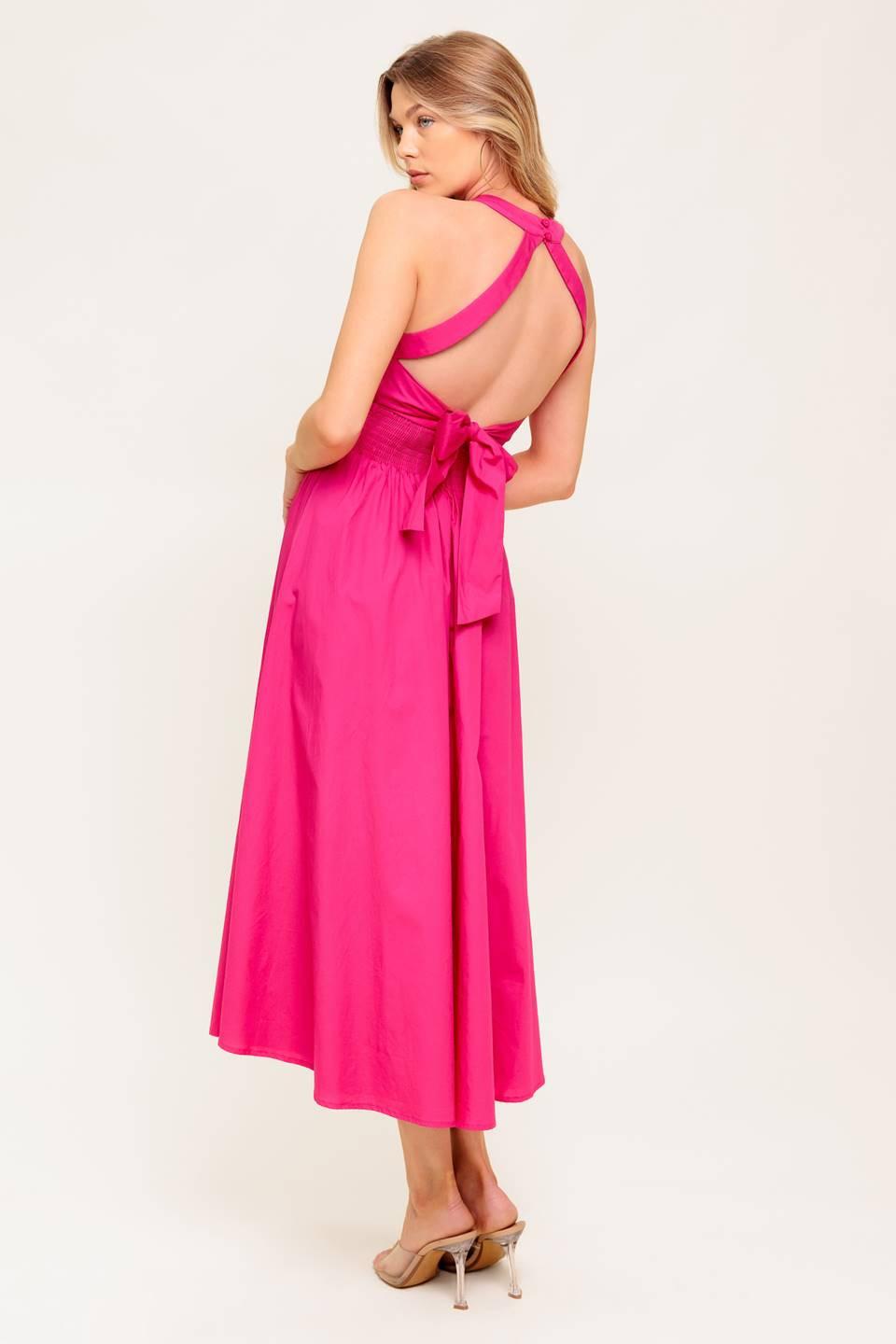 A solid hot pink woven midi dress featuring halter neckline, lace inset detail, smocked back waistband and bare back with button/tie closure.