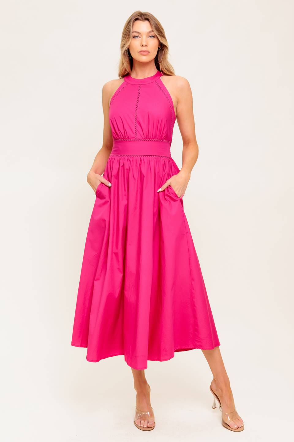 A solid hot pink woven midi dress featuring halter neckline, lace inset detail, smocked back waistband and bare back with button/tie closure.
