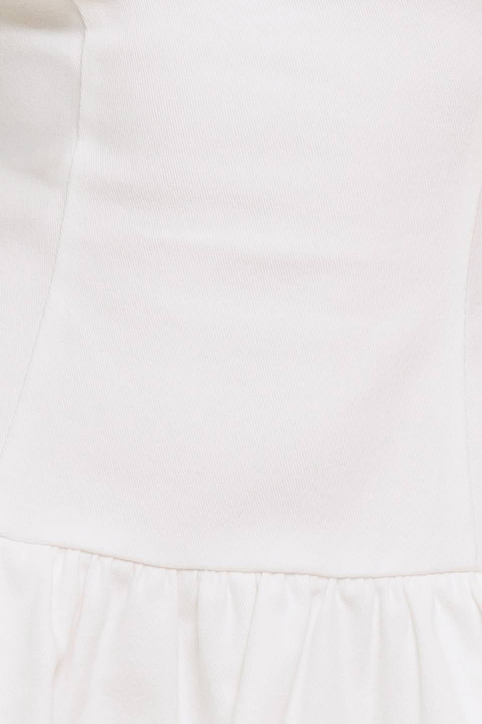 A solid woven twill mini dress featuring strapless, drop waist, bubble hemline and back zipper closure