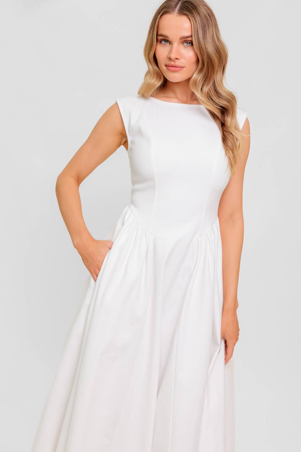 A solid woven midi dress featuring wide neckline, sleeveless, full skirt with U back and zipper closure