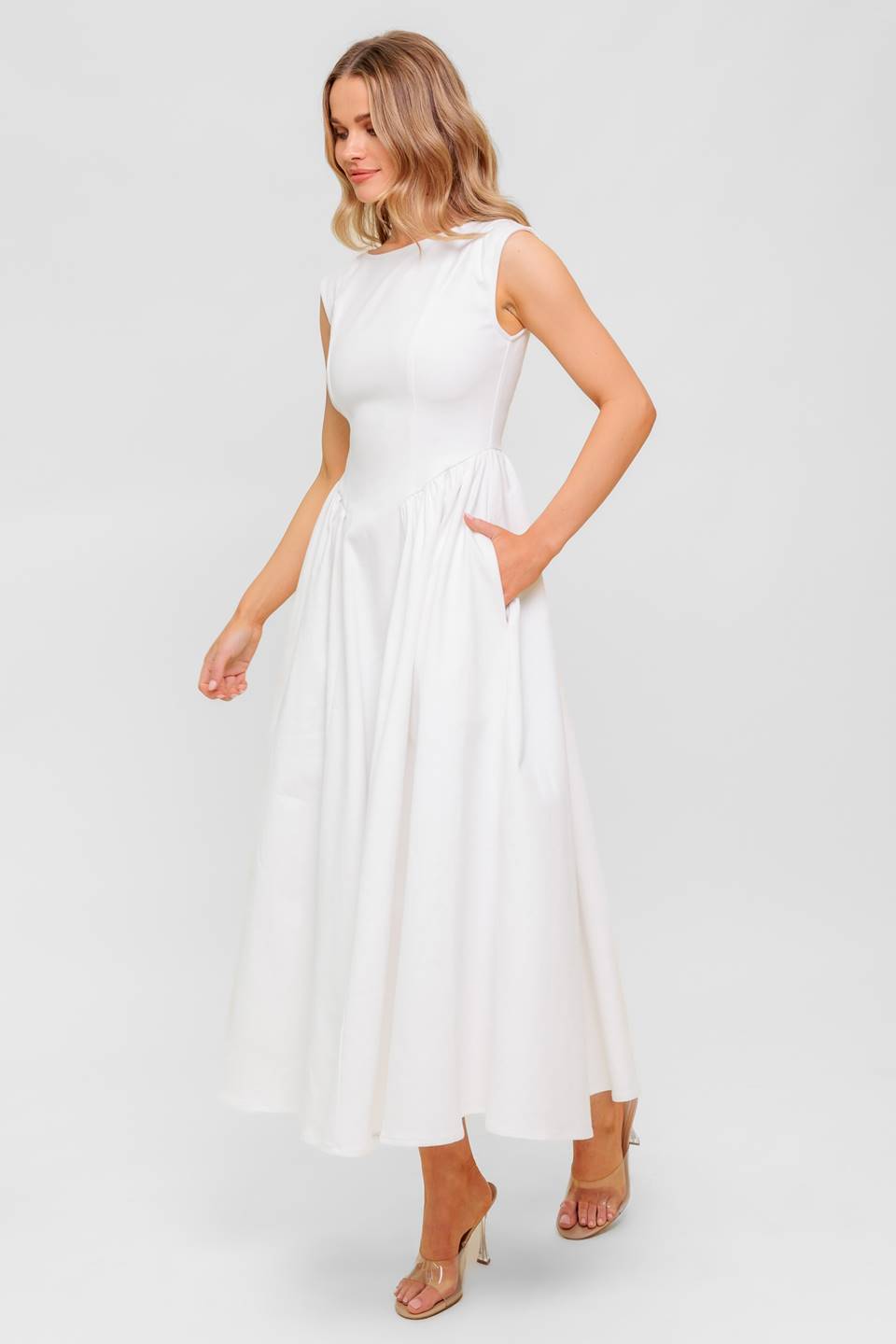 A solid woven midi dress featuring wide neckline, sleeveless, full skirt with U back and zipper closure