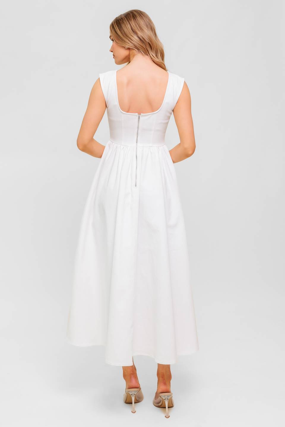 A solid woven midi dress featuring wide neckline, sleeveless, full skirt with U back and zipper closure