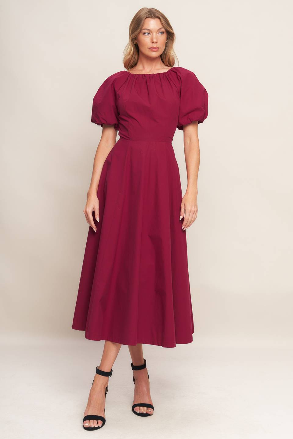 A solid woven midi dress featuring round neckline with shirred edge, short sleeve, circle skirt and back zipper closure