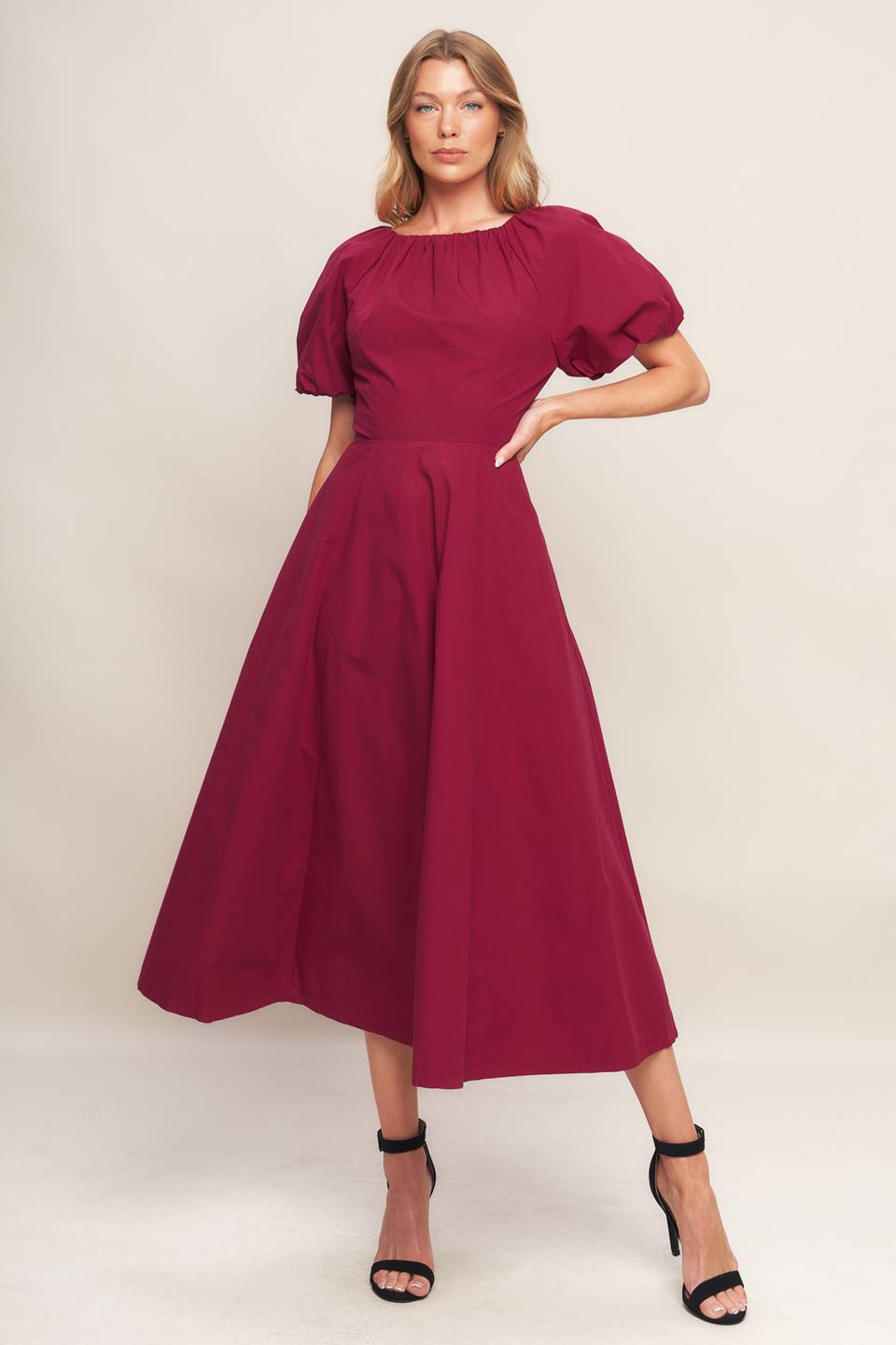 A solid woven midi dress featuring round neckline with shirred edge, short sleeve, circle skirt and back zipper closure