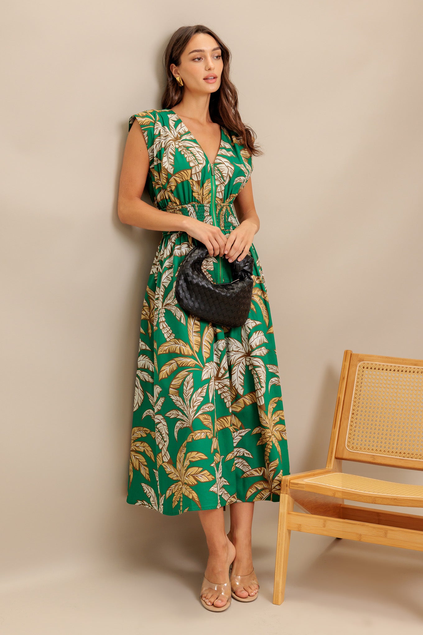 A printed woven midi dress featuring V neckline, dropped shoulder, smocked wide waistband and front zipper closure