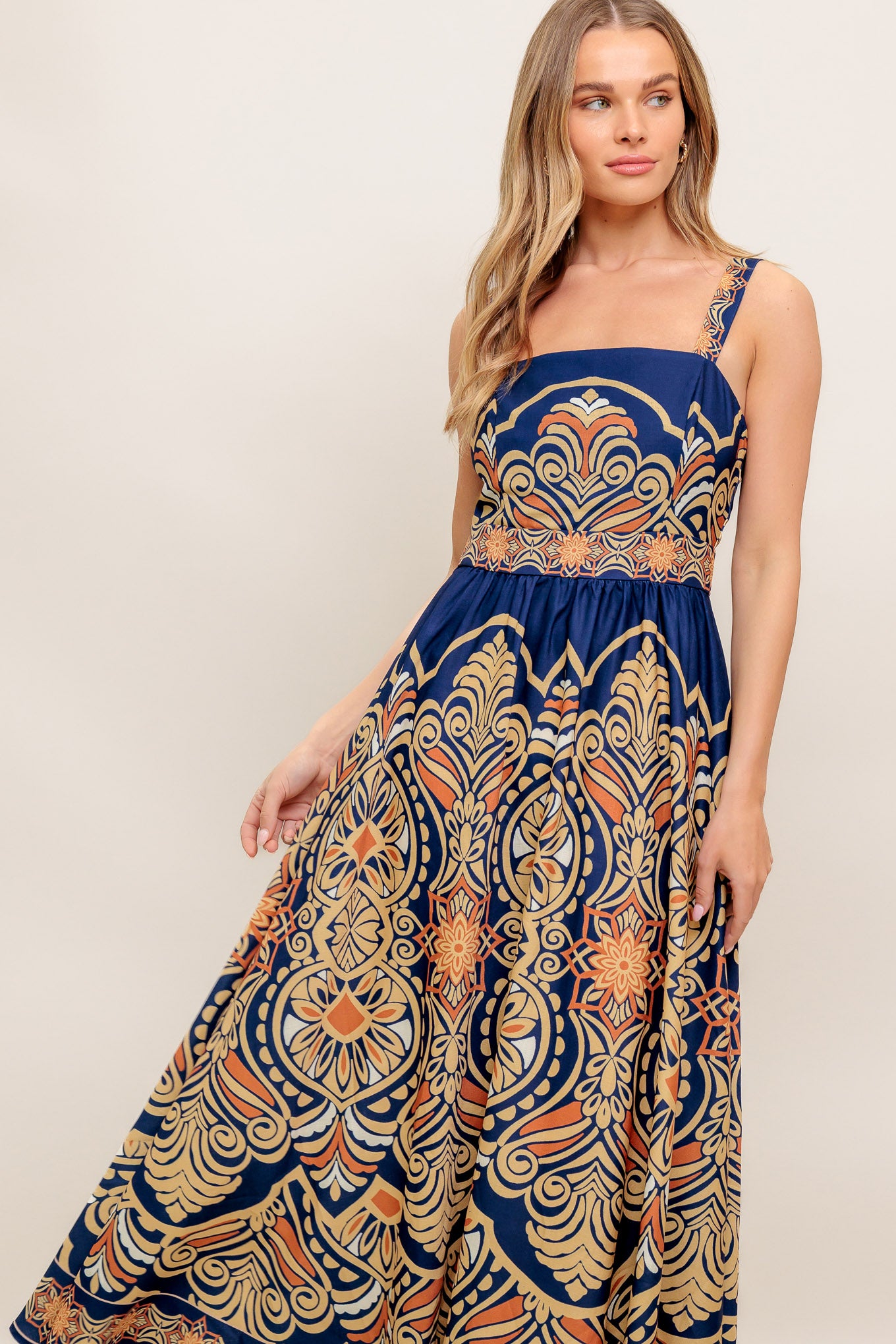 A printed woven midi dress featuring straight neckline, straps, full skirt and back zipper closure