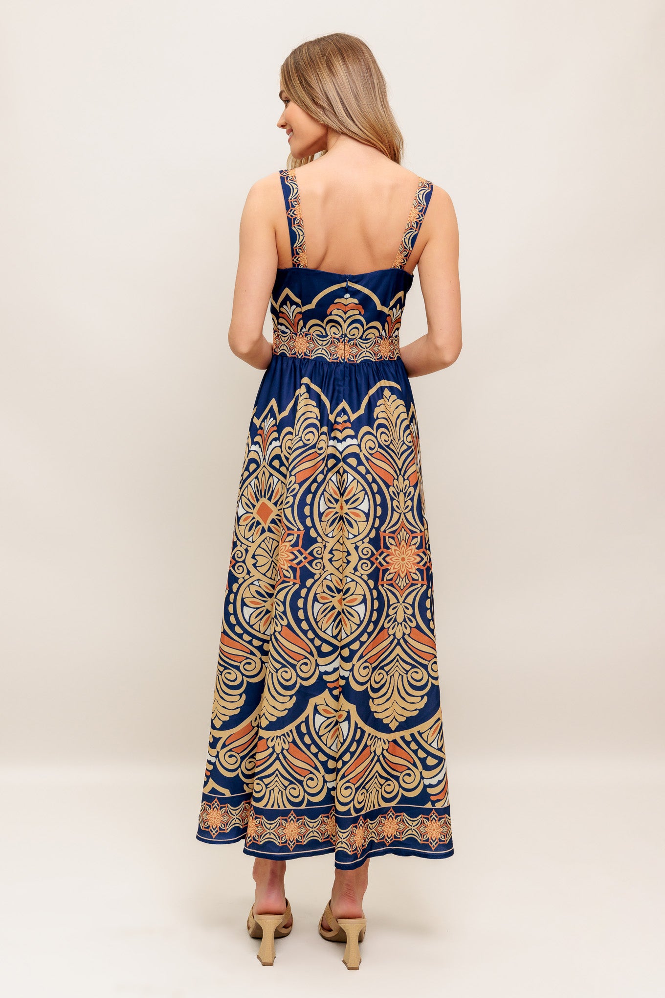 A printed woven midi dress featuring straight neckline, straps, full skirt and back zipper closure