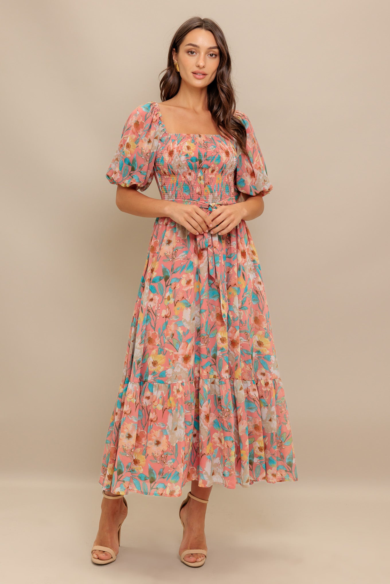 A printed woven midi dress featuring square neckline, short puff sleeve, smocked bodice, self sash tie and ruffled hemline