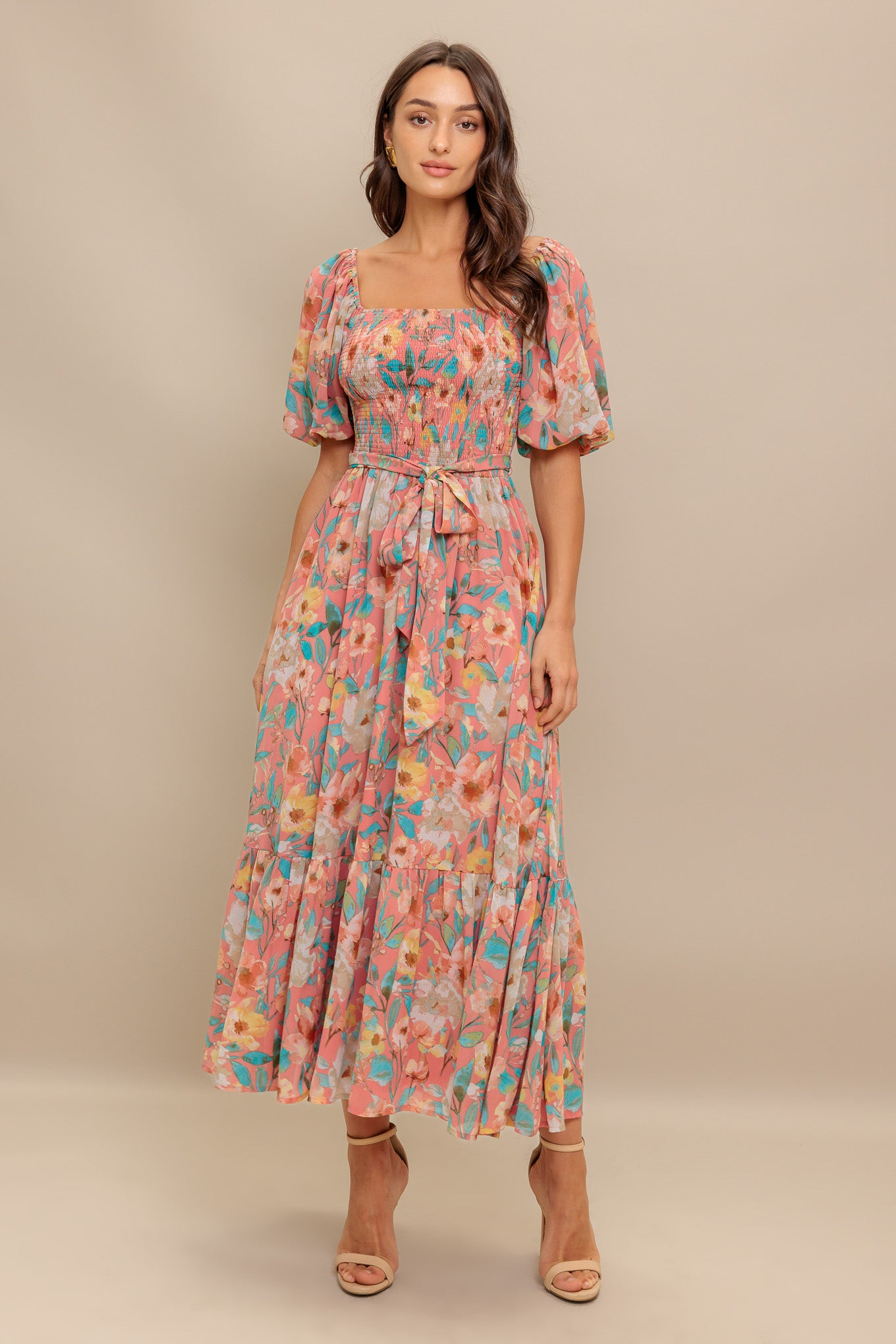A printed woven midi dress featuring square neckline, short puff sleeve, smocked bodice, self sash tie and ruffled hemline