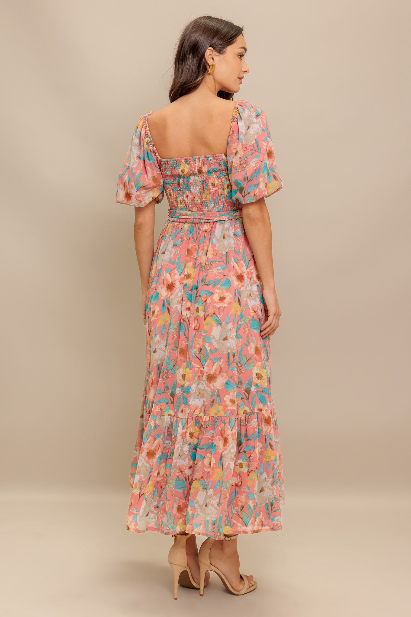 A printed woven midi dress featuring square neckline, short puff sleeve, smocked bodice, self sash tie and ruffled hemline