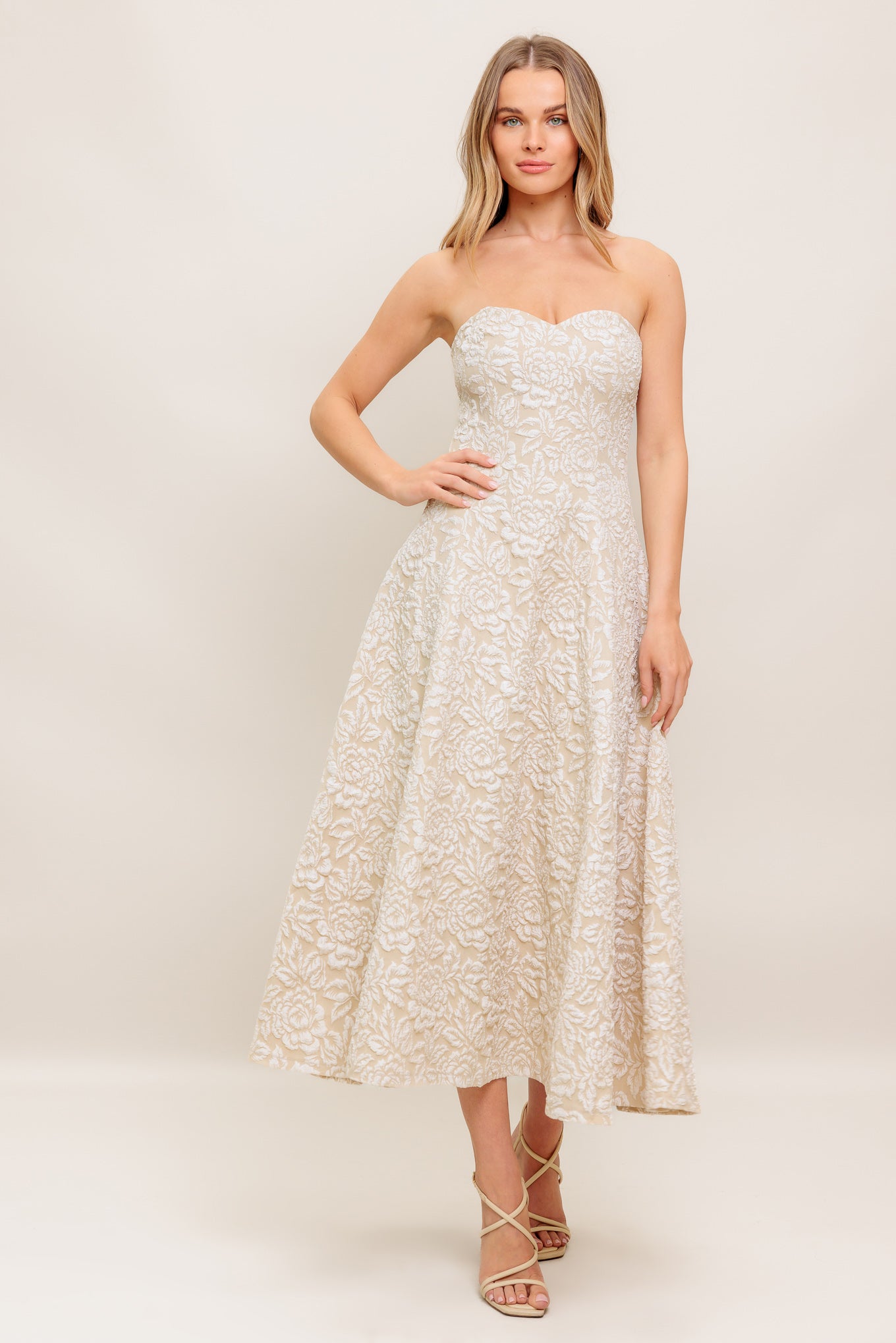 A textured woven midi dress featuring strapless sweetheart neckline, circle skirt and back zipper closure
