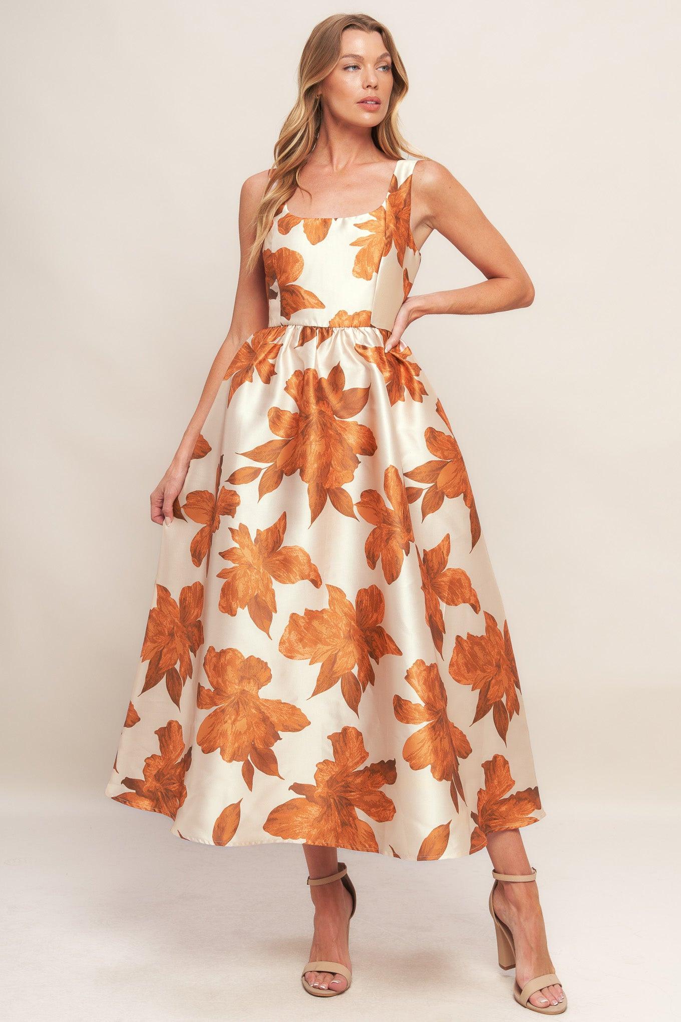 A printed woven midi dress featuring U neckline, sleeveless, full skirt and back zipper closure