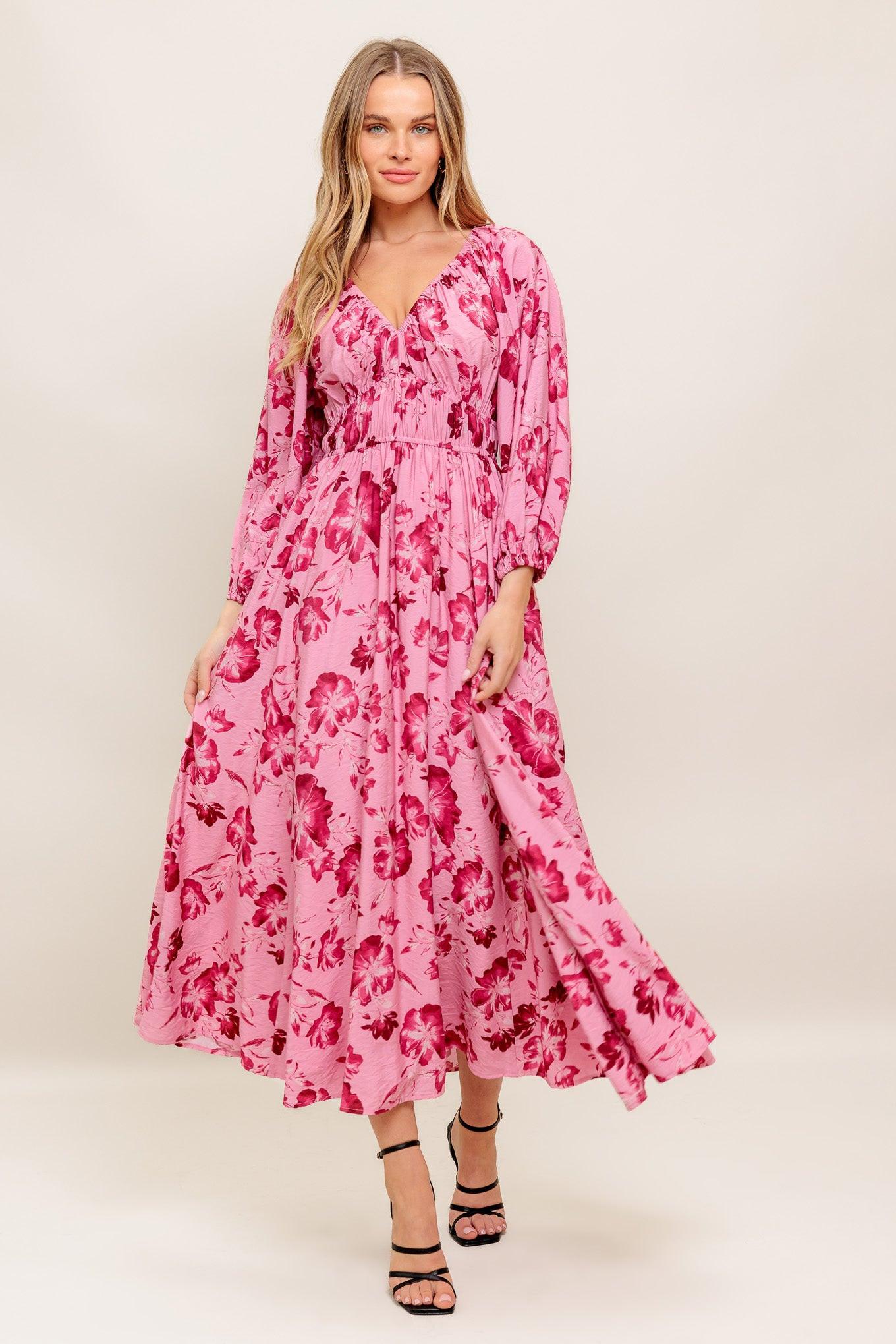 A printed woven midi dress featuring V neckline, 3/4 sleeve, waist yoke and elasticized waist