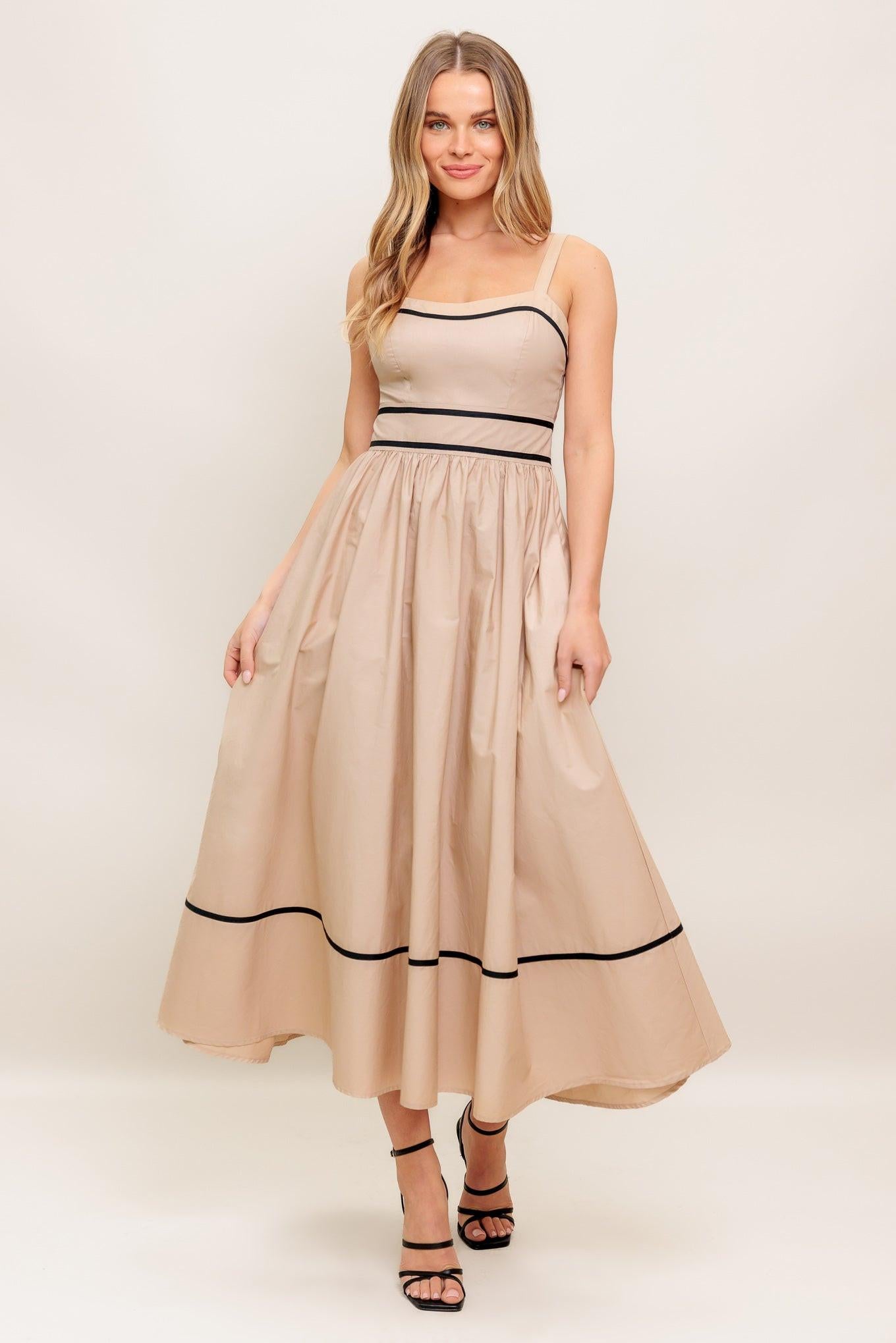 A solid woven midi dress featuring sweetheart neckline, straps, full skirt and back zipper closure
