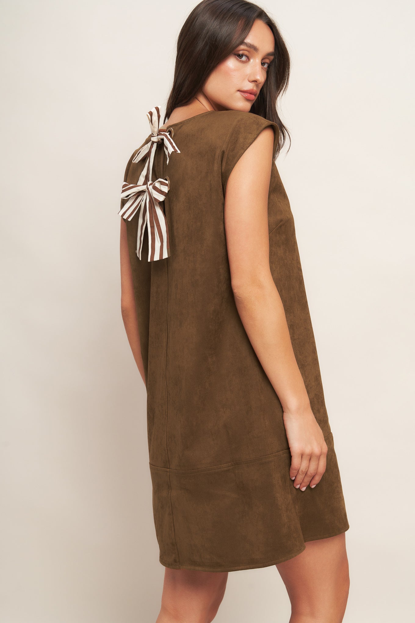A faux suede midi shift dress featuring round neckline, cap sleeve and back neck tie closure