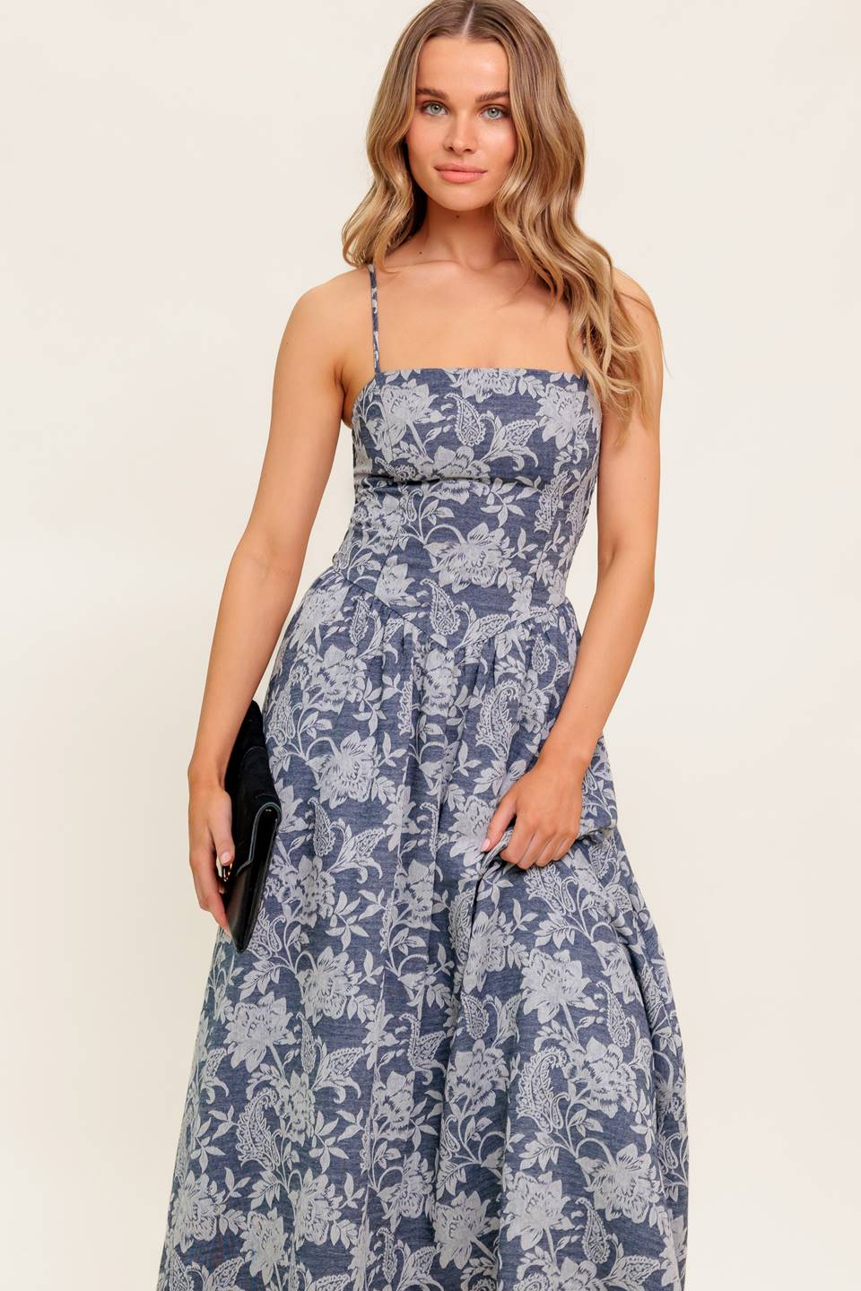 A jacquard woven midi dress featuring straight neckline, straps, full skirt and smocked back bodice.