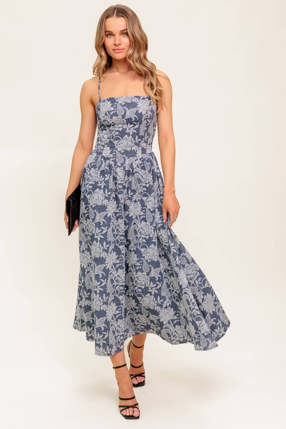 A jacquard woven midi dress featuring straight neckline, straps, full skirt and smocked back bodice.