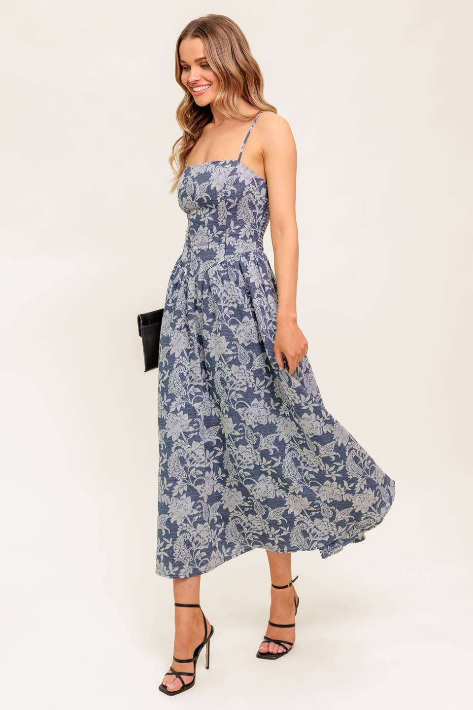 A jacquard woven midi dress featuring straight neckline, straps, full skirt and smocked back bodice.