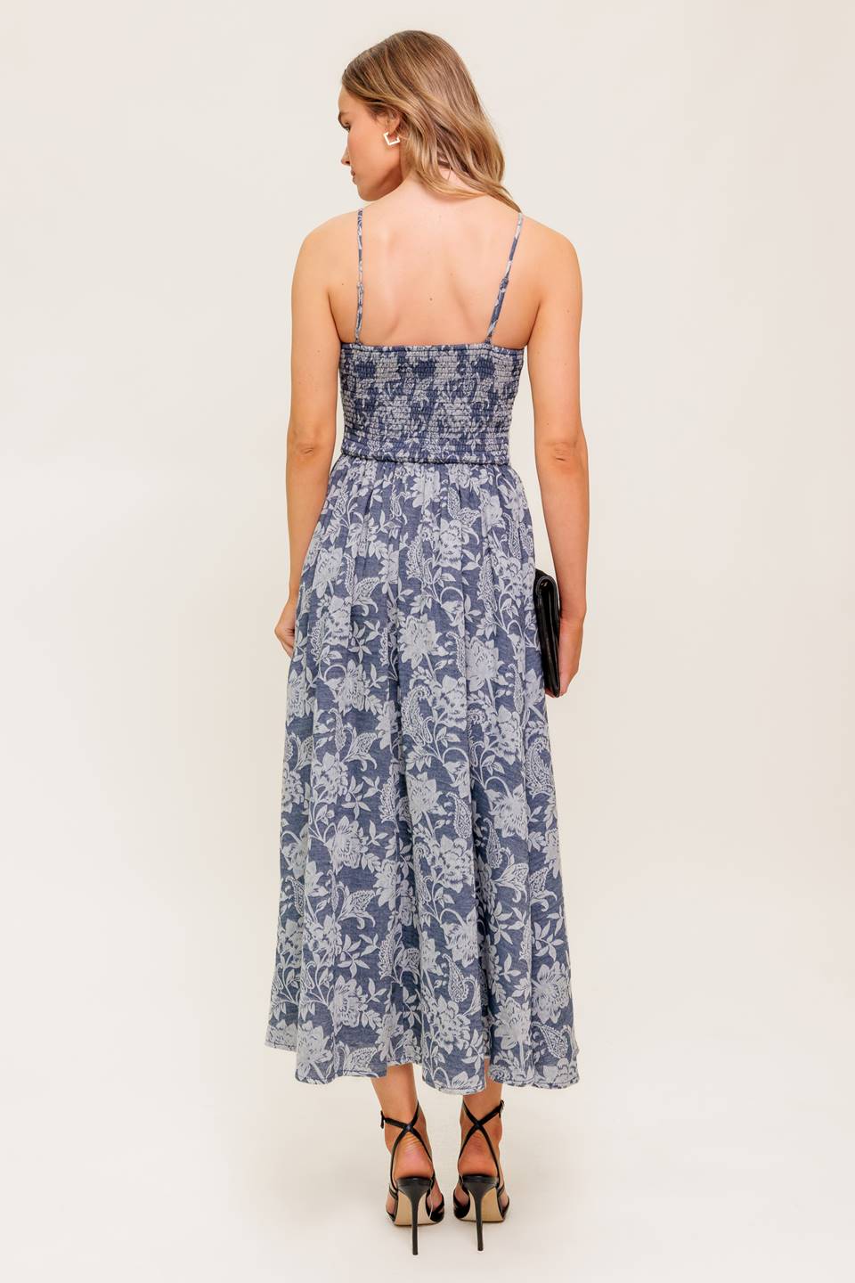 A jacquard woven midi dress featuring straight neckline, straps, full skirt and smocked back bodice.