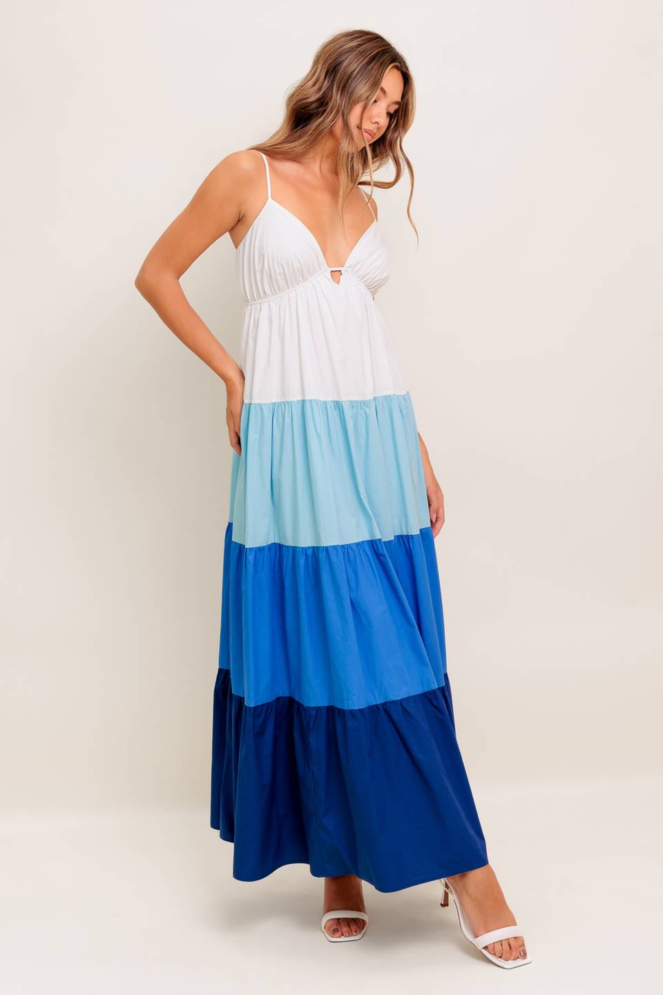 A color blocked woven maxi dress featuring cami top with straps, tiered skirt and back tie closure
