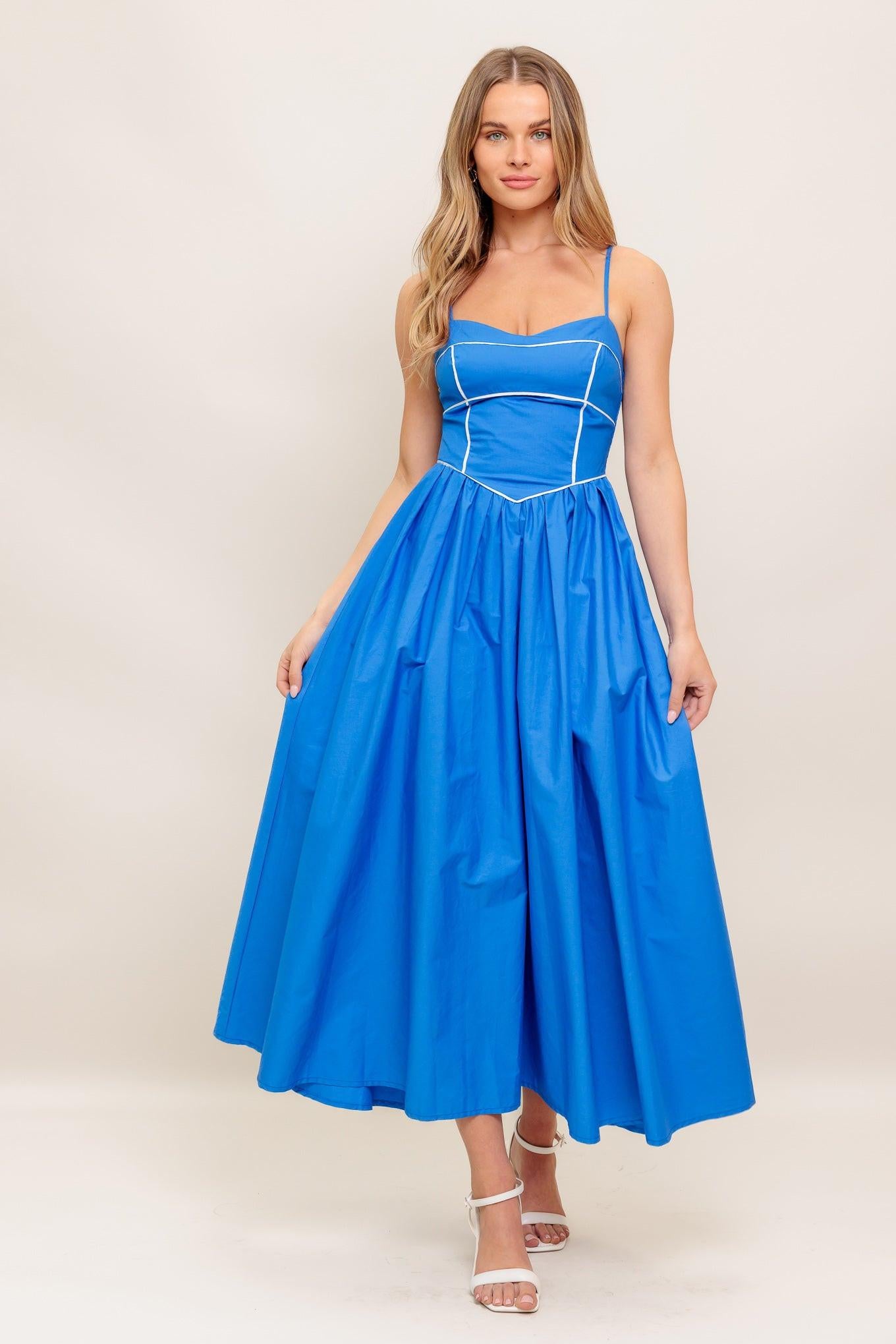 A solid woven midi dress featuring sweetheart neckline, straps, basque waist, full skirt and smocked back bodice