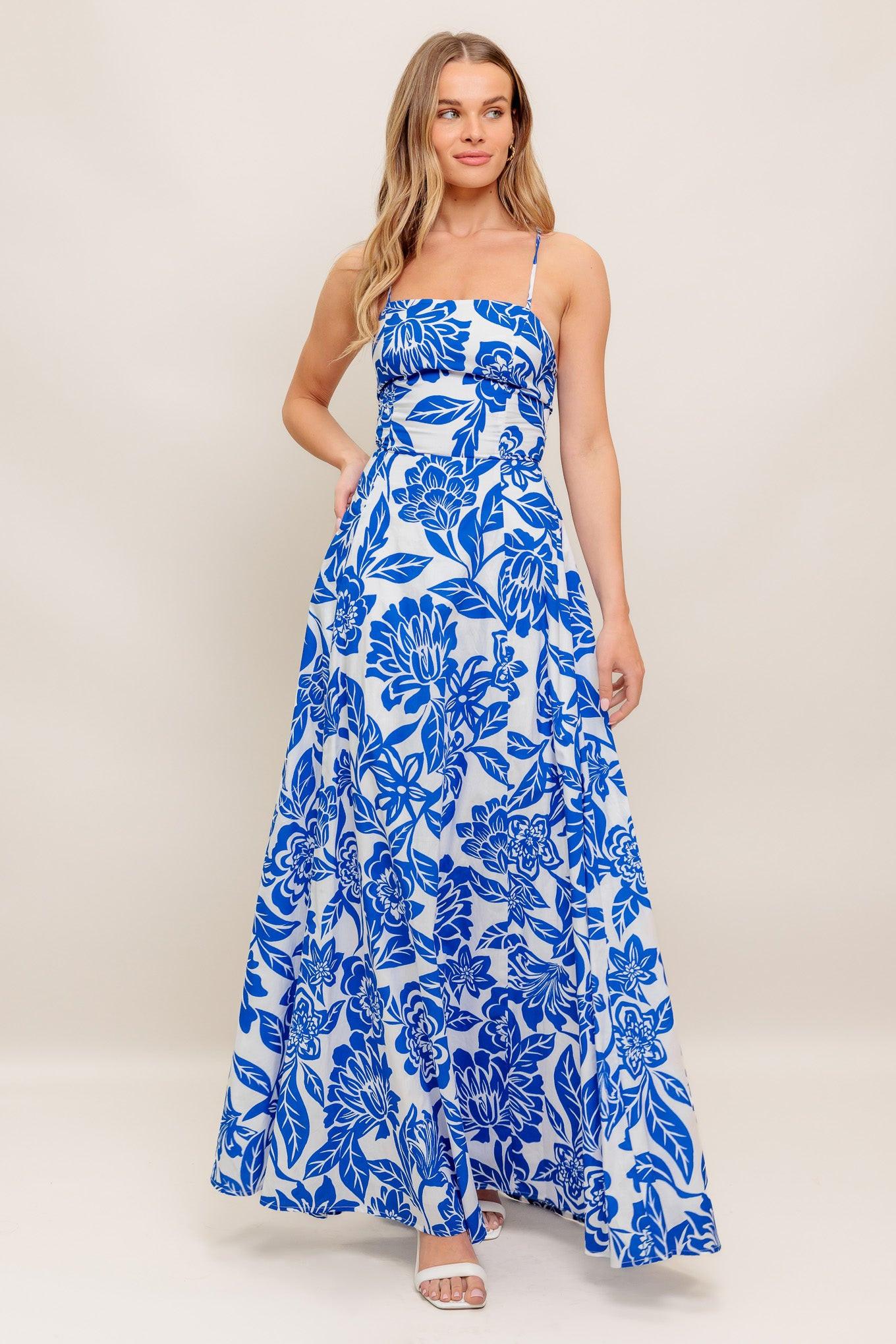 A printed woven ankle dress featuring straight neckline, circle skirt, bare back with cross straps