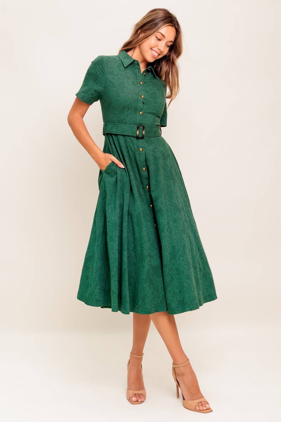 A jacquard woven midi dress featuring collar, short sleeve, button down, self belt, side pocket and full skirt