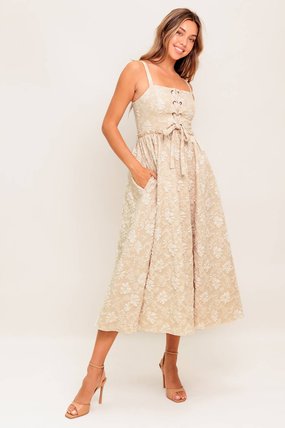 A jacquard woven midi dress featuring straight neckline, straps, front lace up detail, full skirt and smocked back bodice