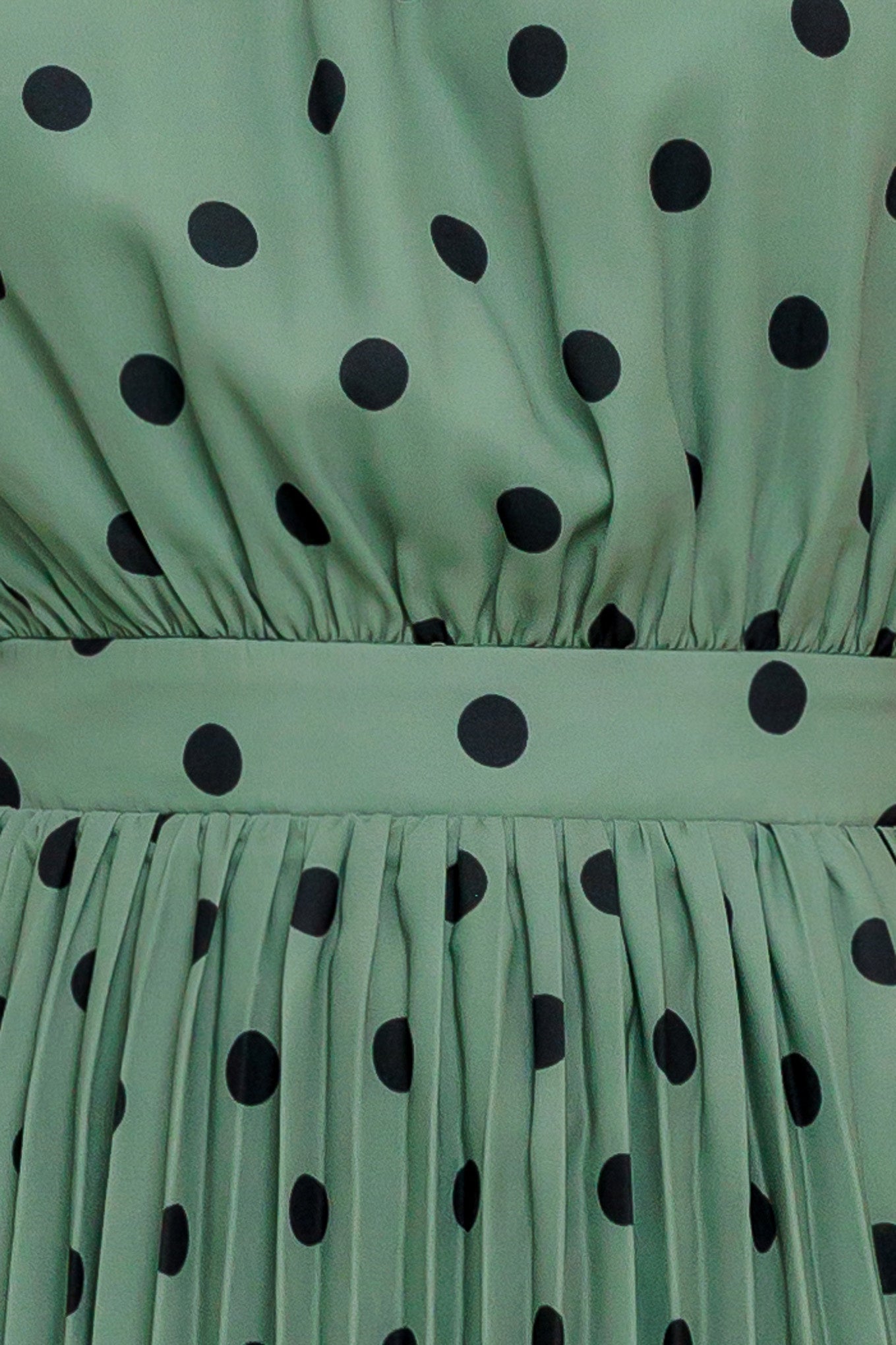A printed woven maxi dress featuring halter neckline with back bow tie, sleeveless, pleated skirt and elasticized back waistband