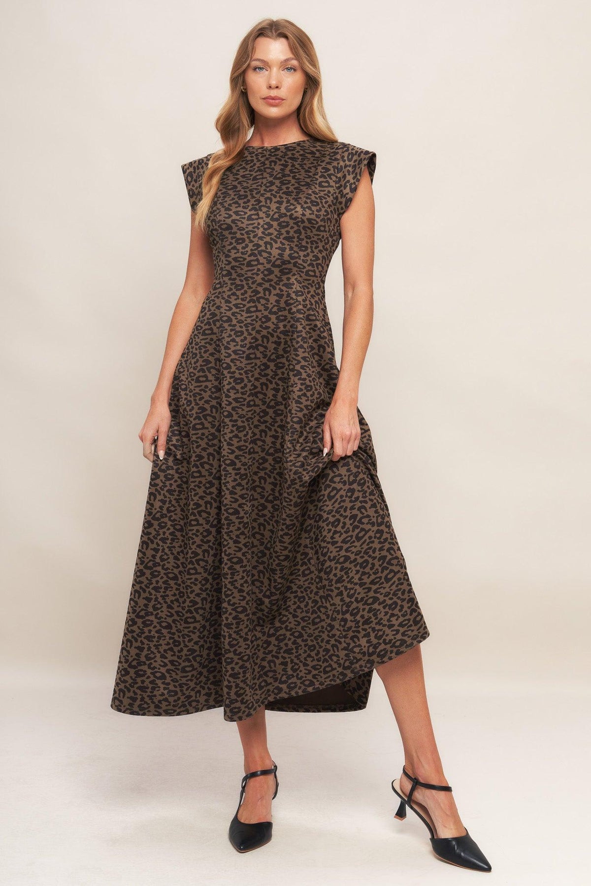 A printed sueded knit midi dress featuring round neckline, cap sleeve, circle skirt and back zipper closure