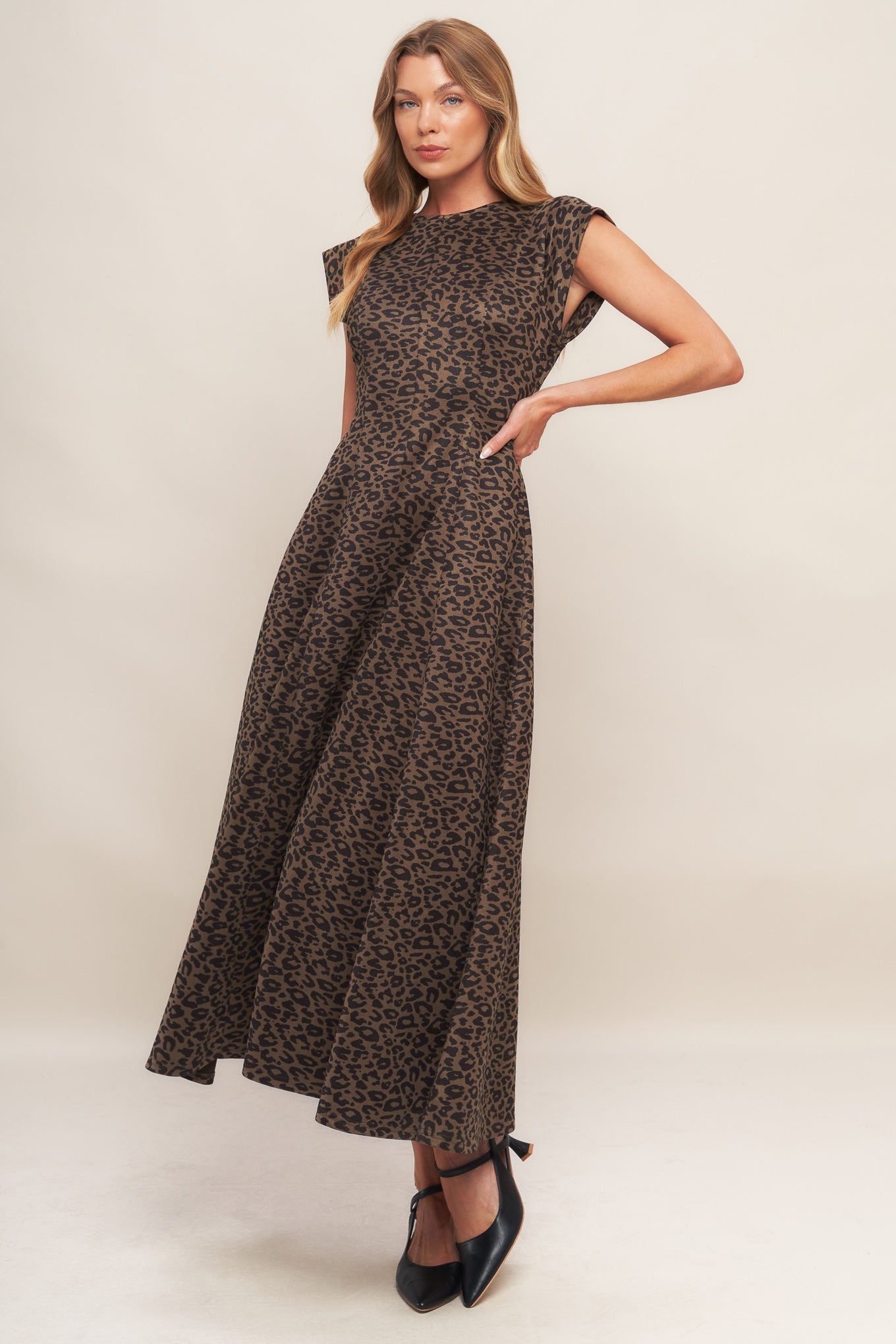 A printed sueded knit midi dress featuring round neckline, cap sleeve, circle skirt and back zipper closure