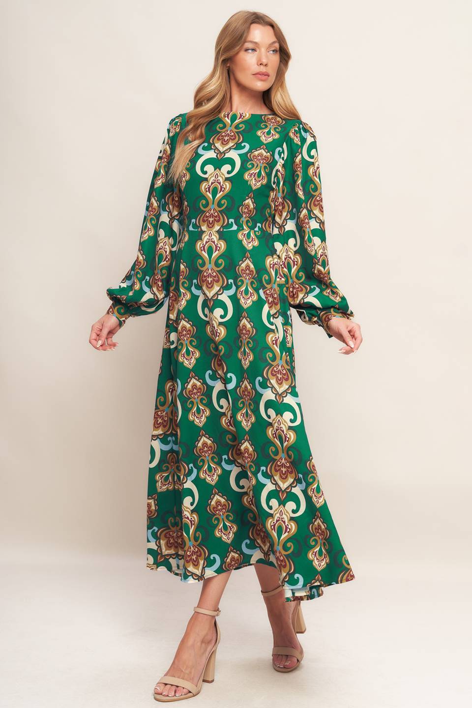 A printed woven midi dress featuring round neckline, long sleeve with cuff, circle skirt, back cut out with tie and zipper closure