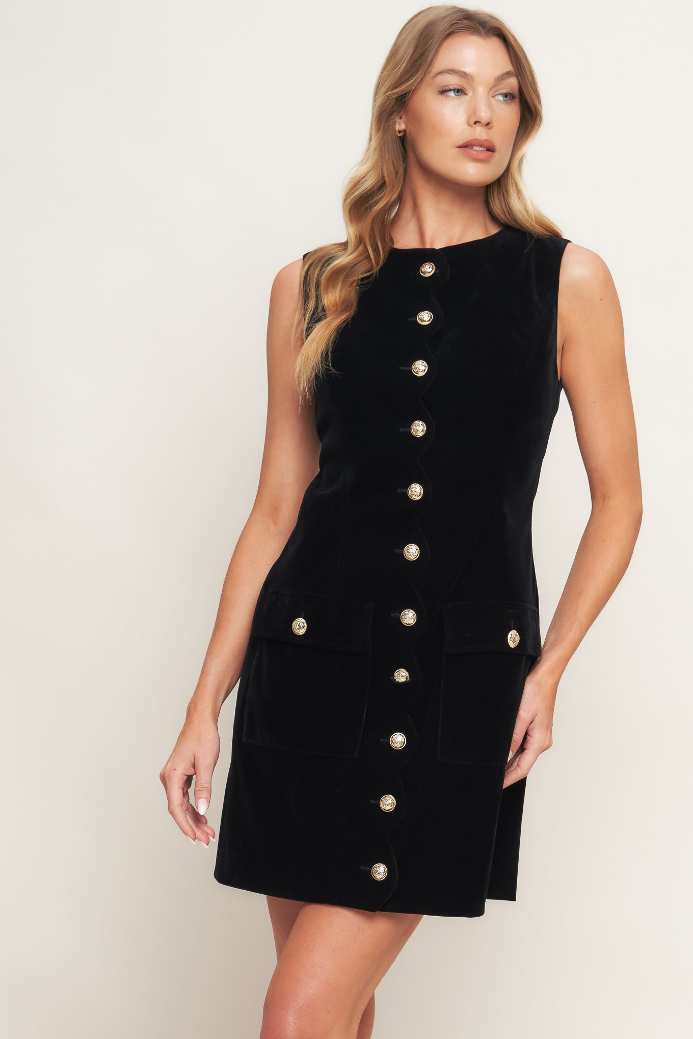 A solid velvet mini dress featuring round neckline, sleeveless and front button down with scalloped placket
