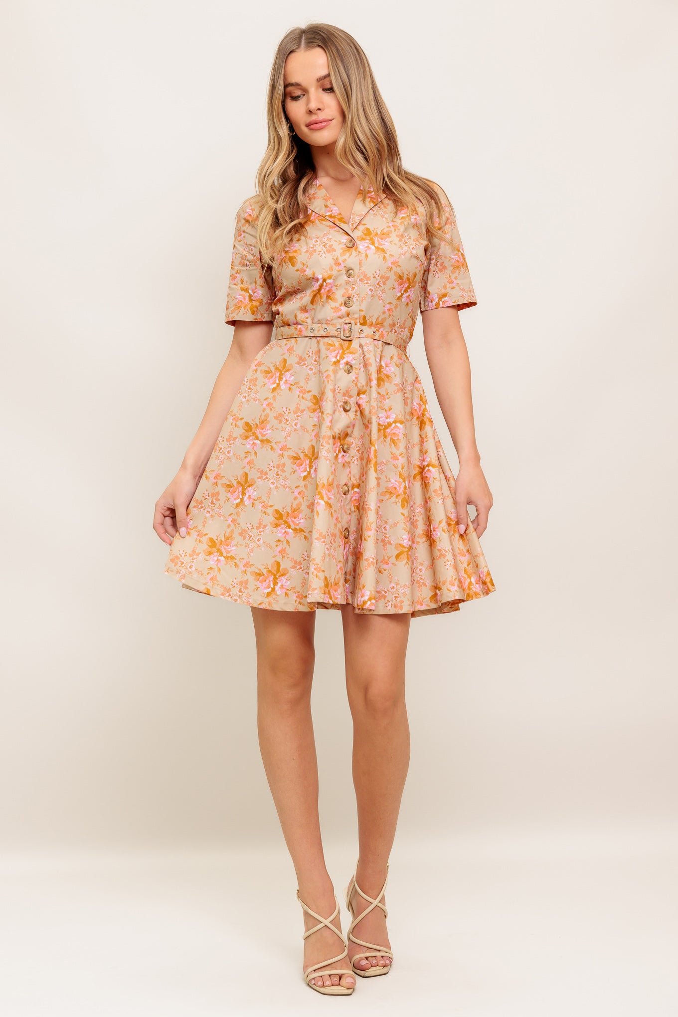 A printed woven mini dress featuring collar, button down, short sleeve, self belt and circle skirt