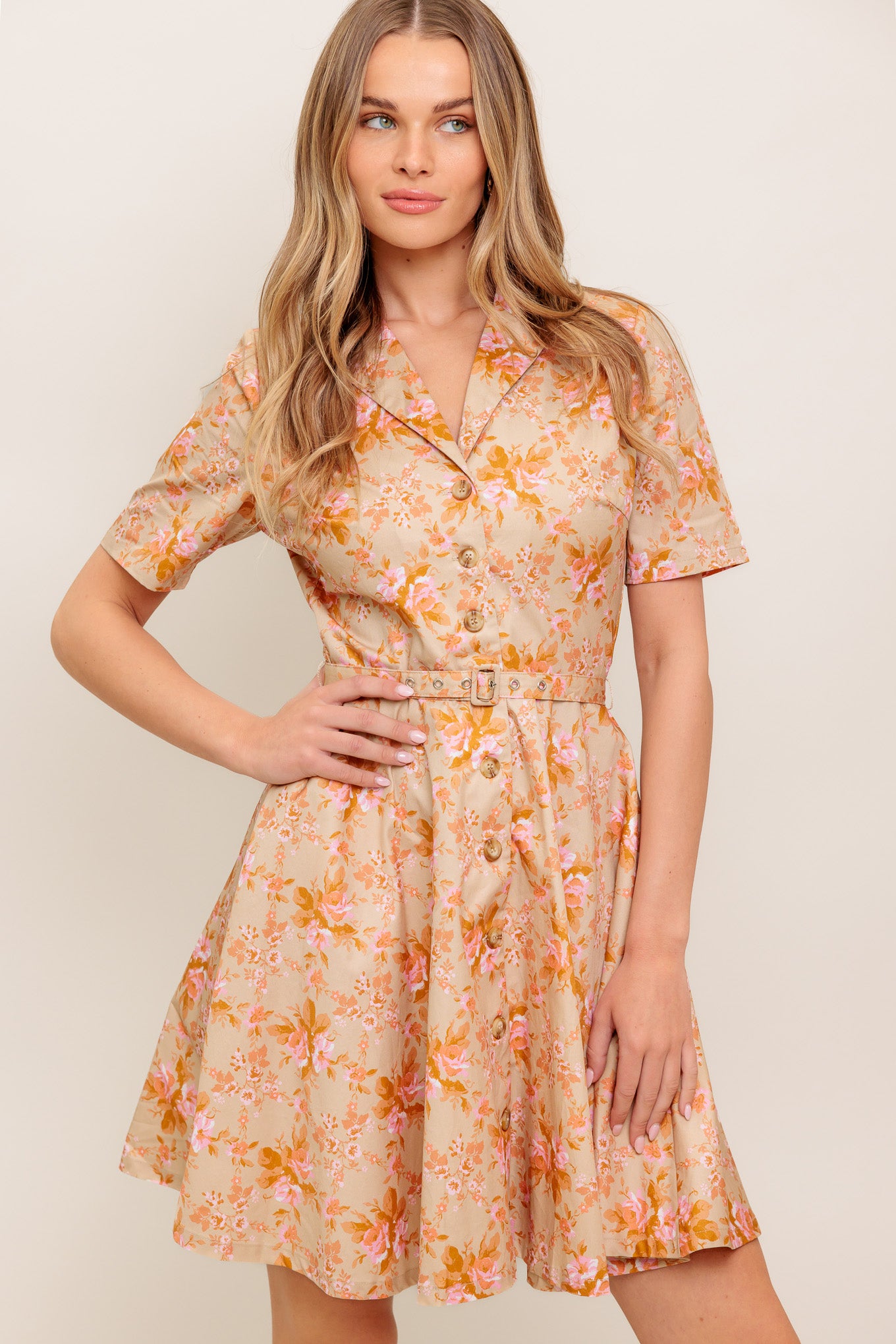 A printed woven mini dress featuring collar, button down, short sleeve, self belt and circle skirt