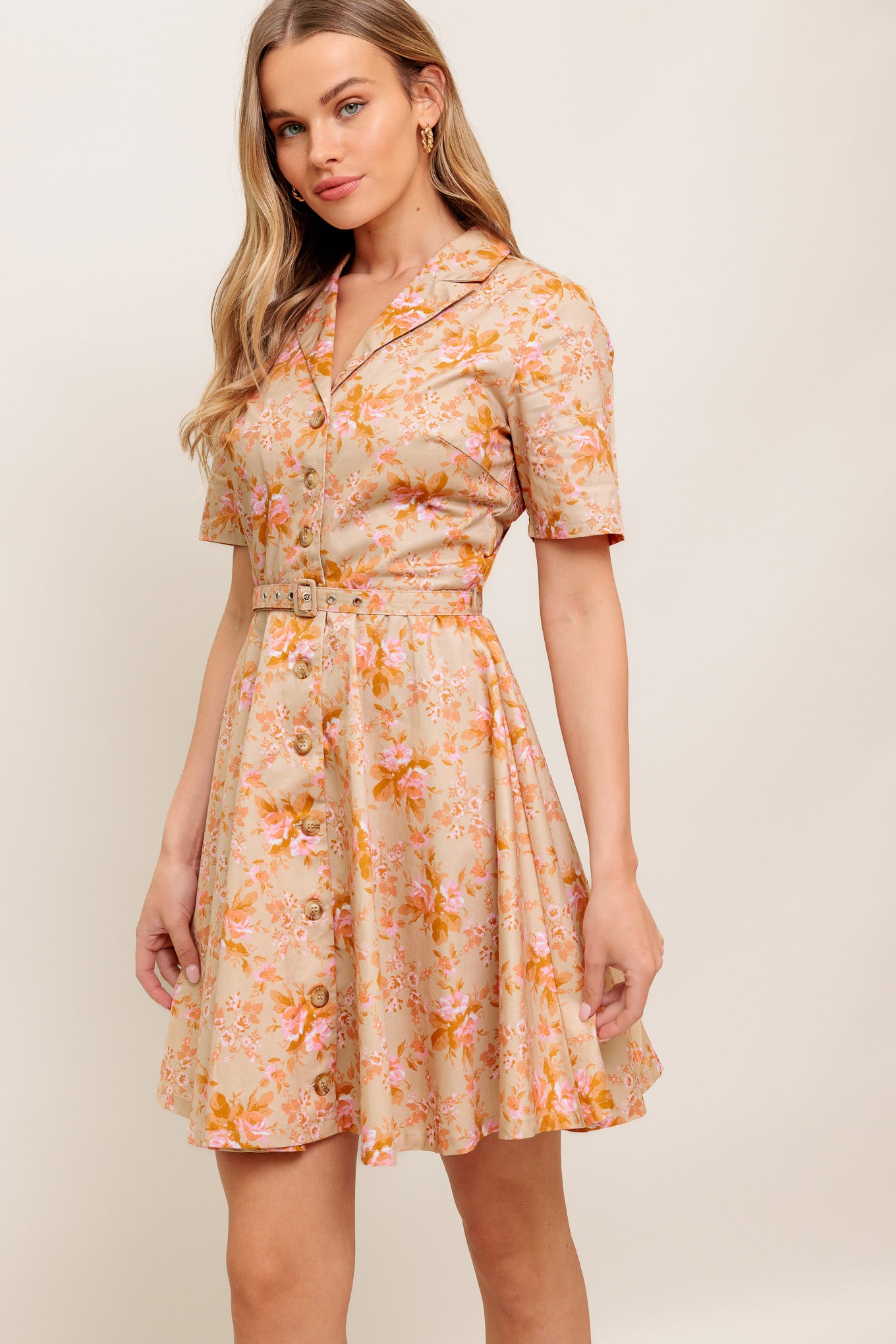 A printed woven mini dress featuring collar, button down, short sleeve, self belt and circle skirt