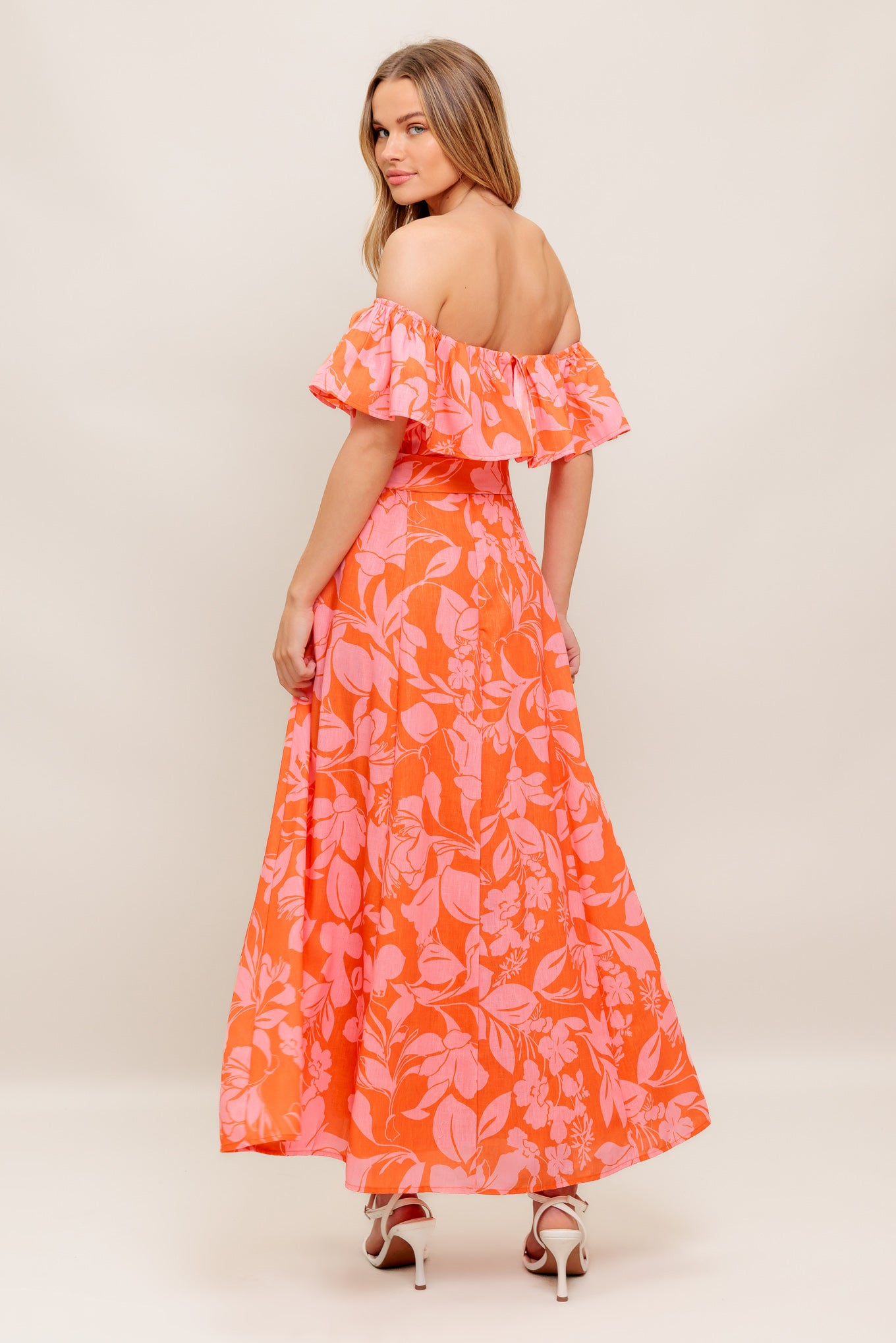 A printed woven midi dress featuring off shoulder neckline with flounce, self sash tie, circle skirt and back zipper closure