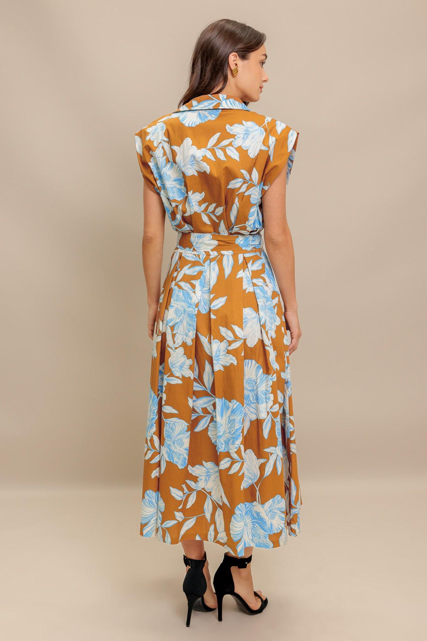A printed woven midi dress featuring collar, short sleeve, front button down, self sash tie and full skirt