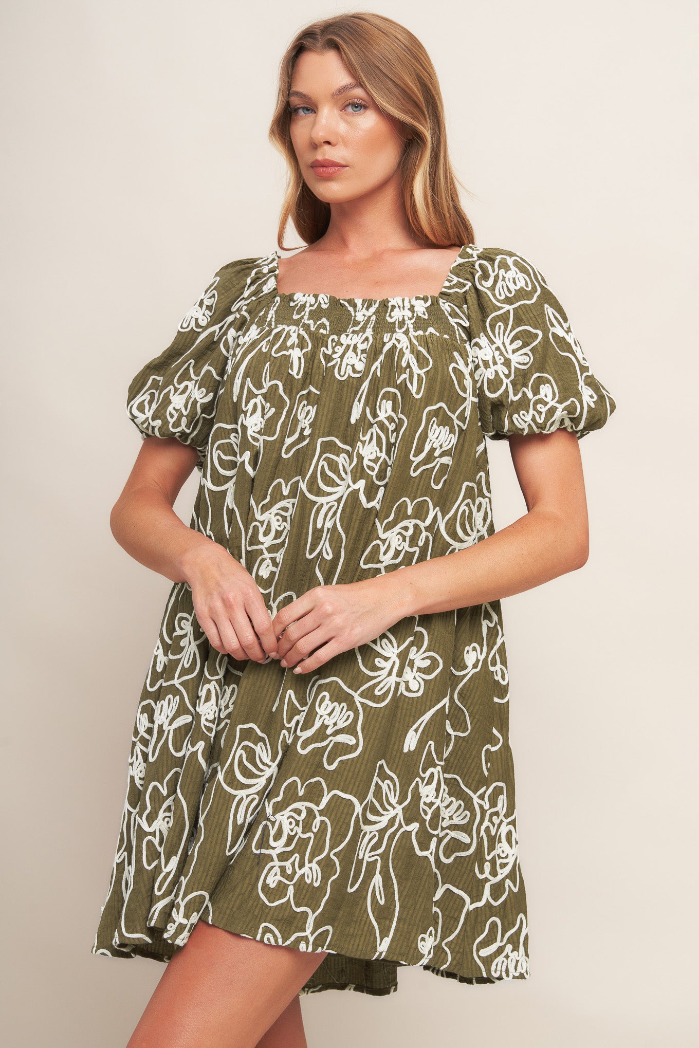 A textured woven mini dress with square neckline and short sleeve