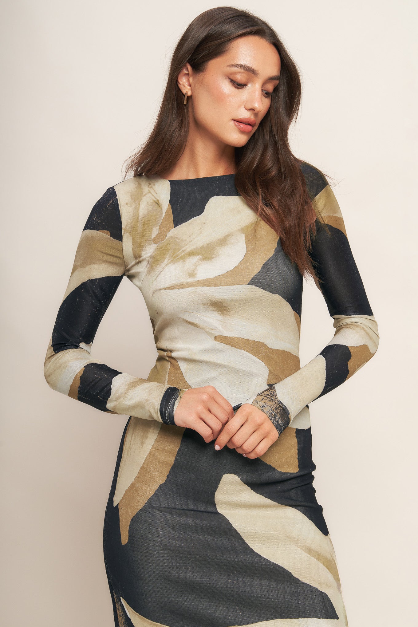 A printed power mesh midi dress featuring round neckline, long sleeve and back neck button closure