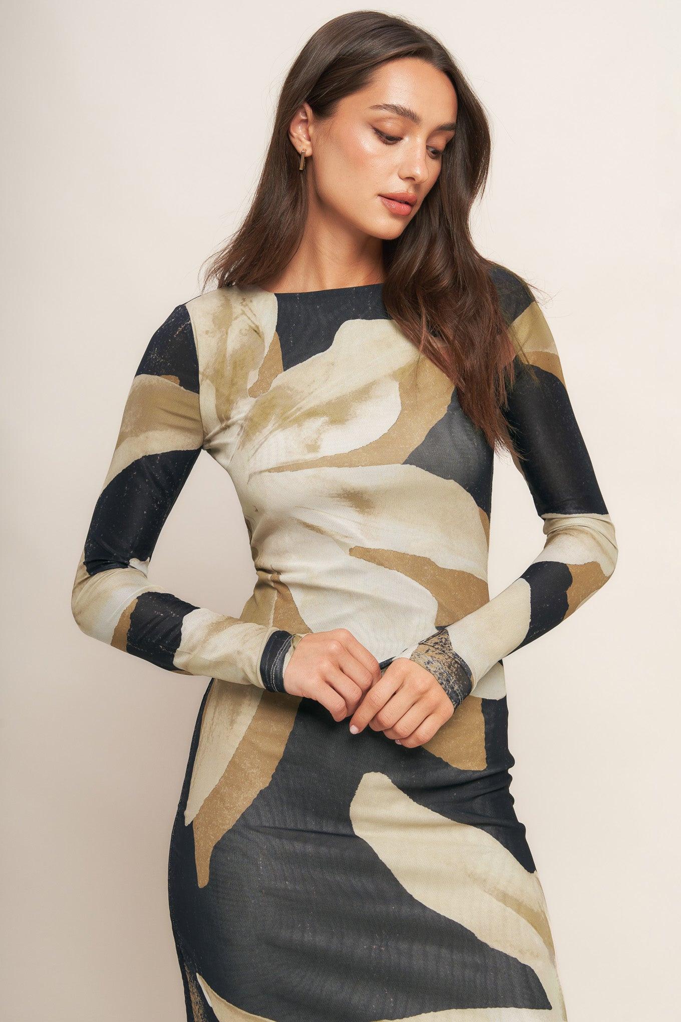 A printed power mesh midi dress featuring round neckline, long sleeve and back neck button closure