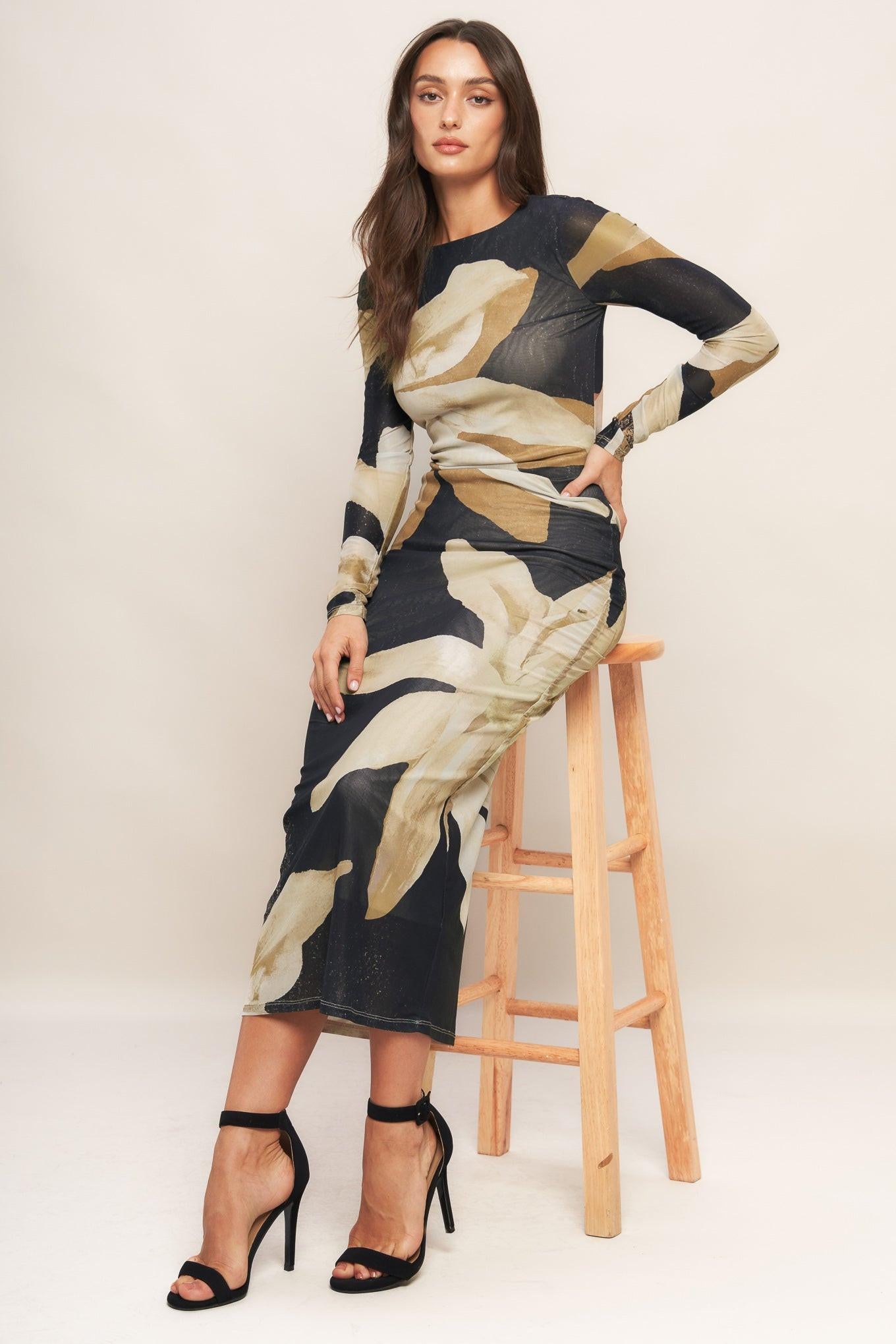 A printed power mesh midi dress featuring round neckline, long sleeve and back neck button closure