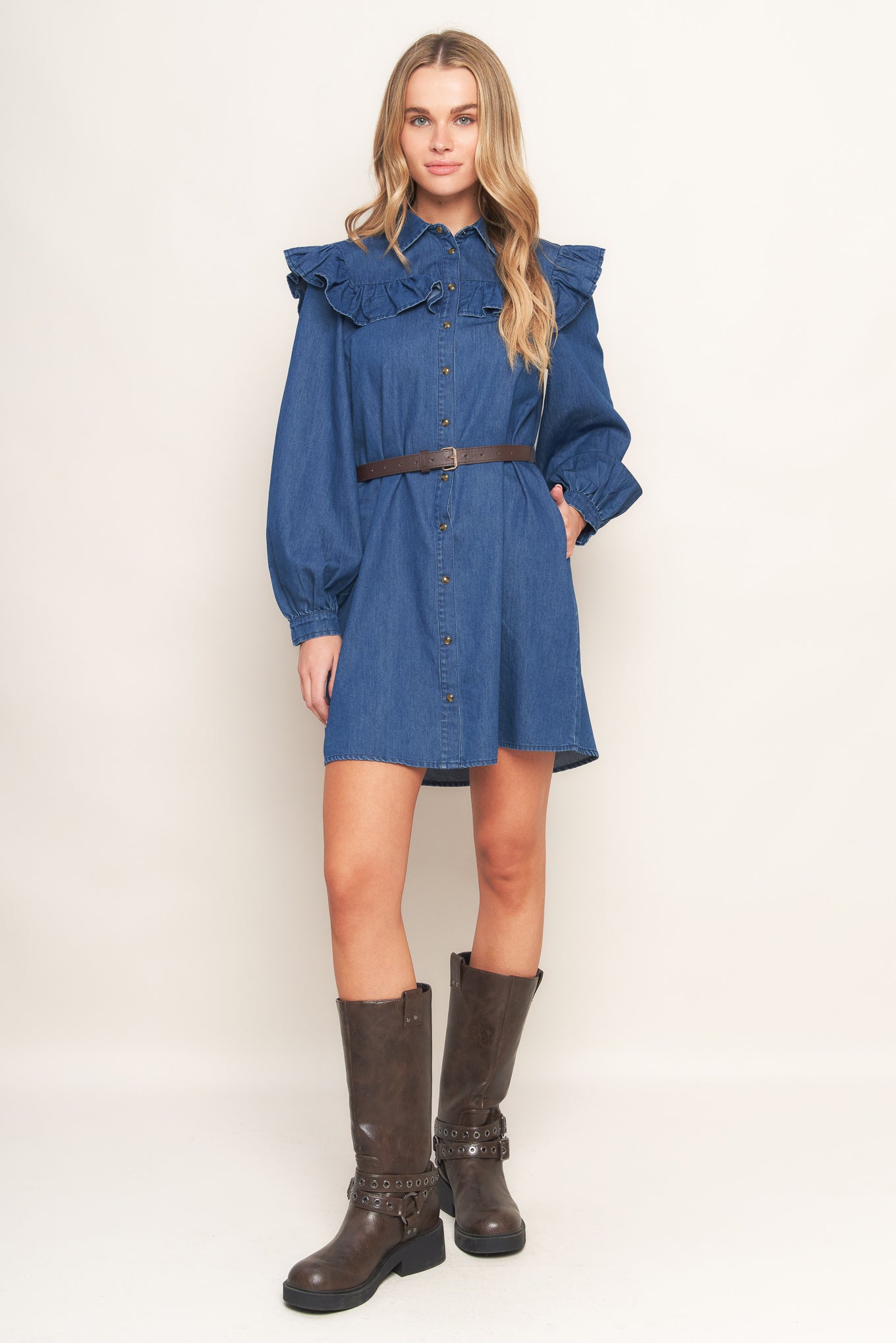 A denim mini dress featuring collar, square yoke with ruffles, long sleeve, front button down and contrasting belt