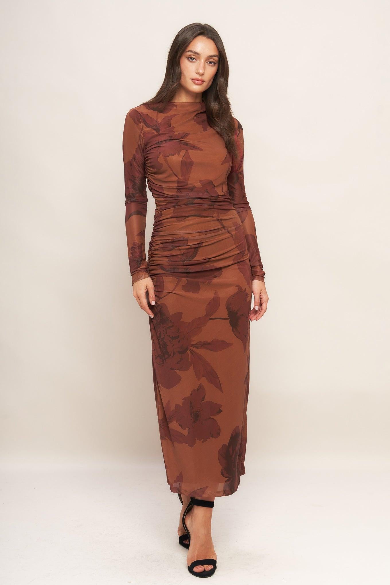 A printed power mesh midi dress featuring long sleeve, side shirring and back zipper closure