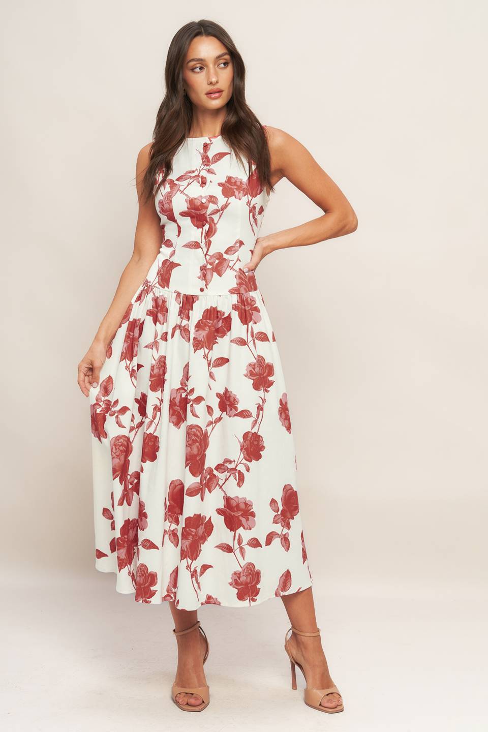 A printed woven midi dress featuring wide round neckline, cap sleeve, scalloped placket with buttons, drop waistline, full skirt and back zipper closure