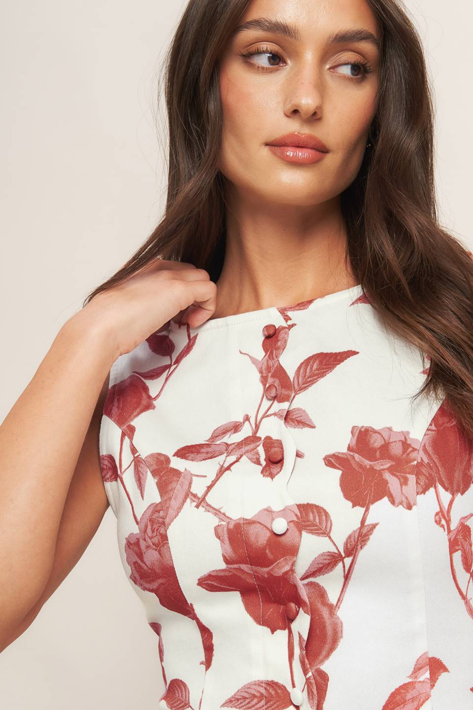 A printed woven midi dress featuring wide round neckline, cap sleeve, scalloped placket with buttons, drop waistline, full skirt and back zipper closure