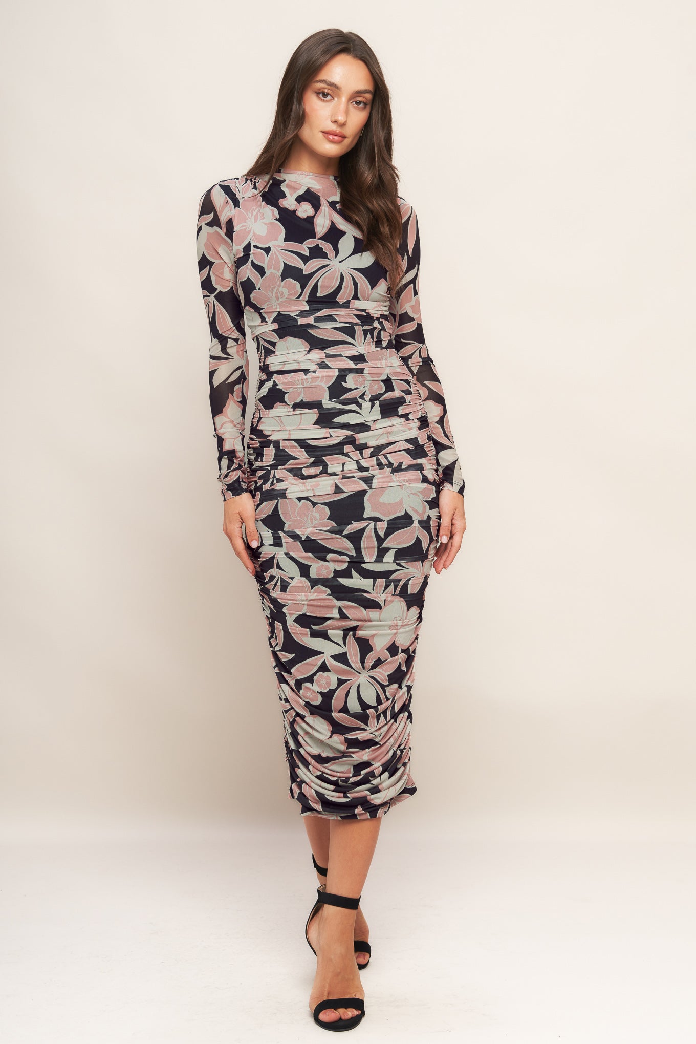 A printed power mesh midi dress featuring body contouring, long sleeve, shirred side and back zipper closure