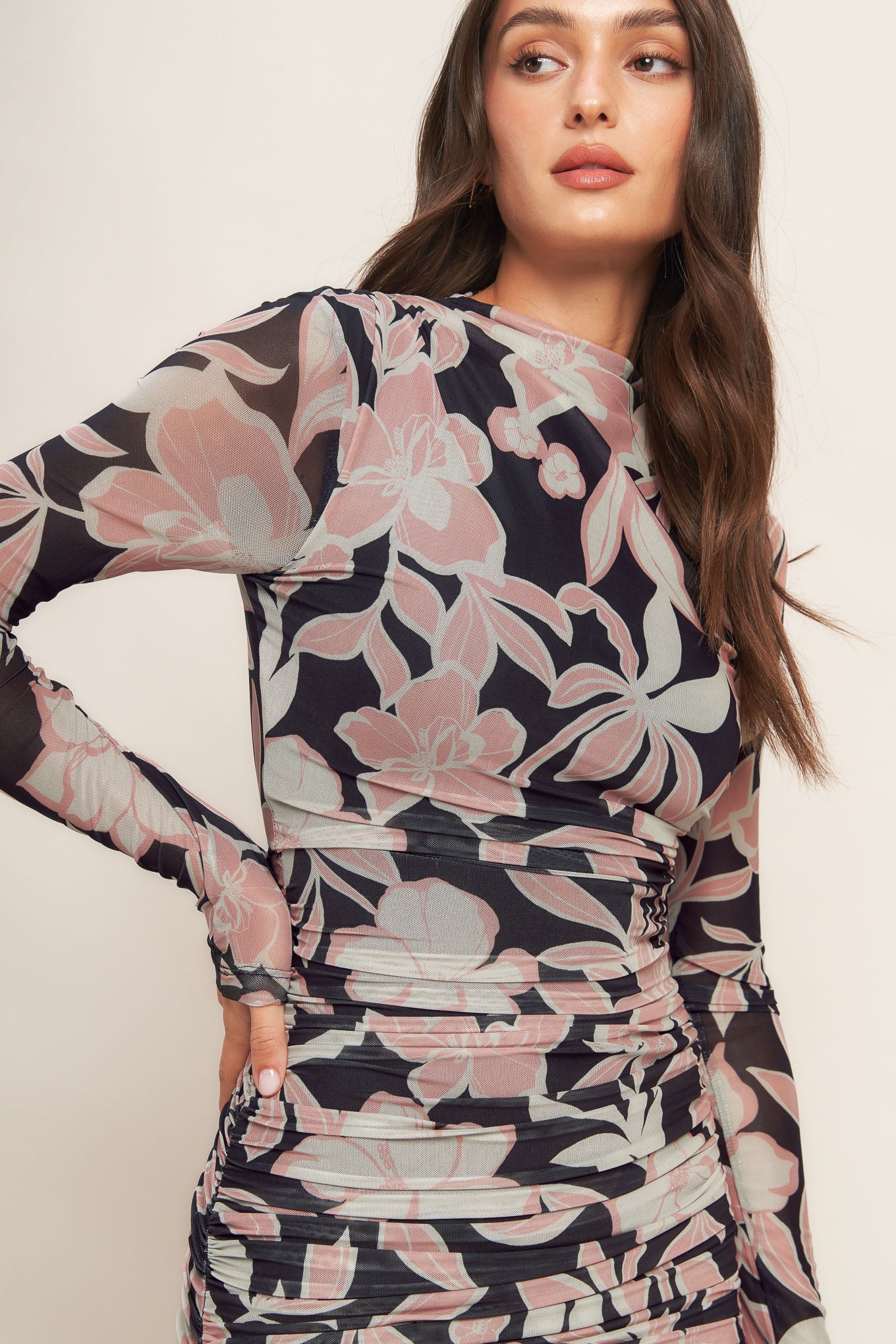 A printed power mesh midi dress featuring body contouring, long sleeve, shirred side and back zipper closure
