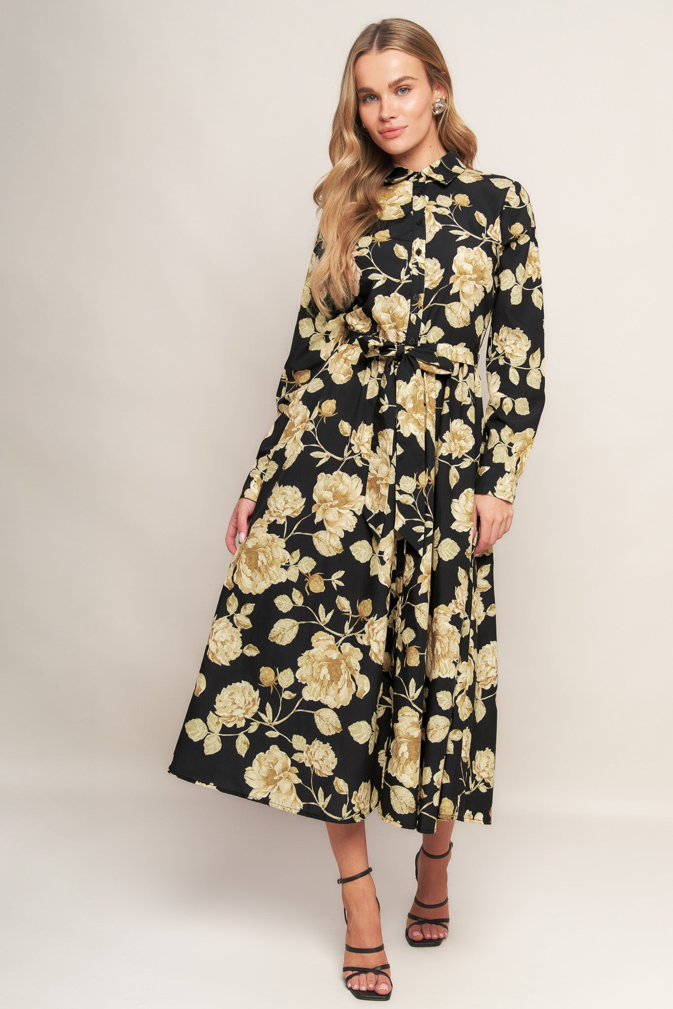 A printed woven midi dress featuring collar, long sleeve, front button down, self sash and full skirt