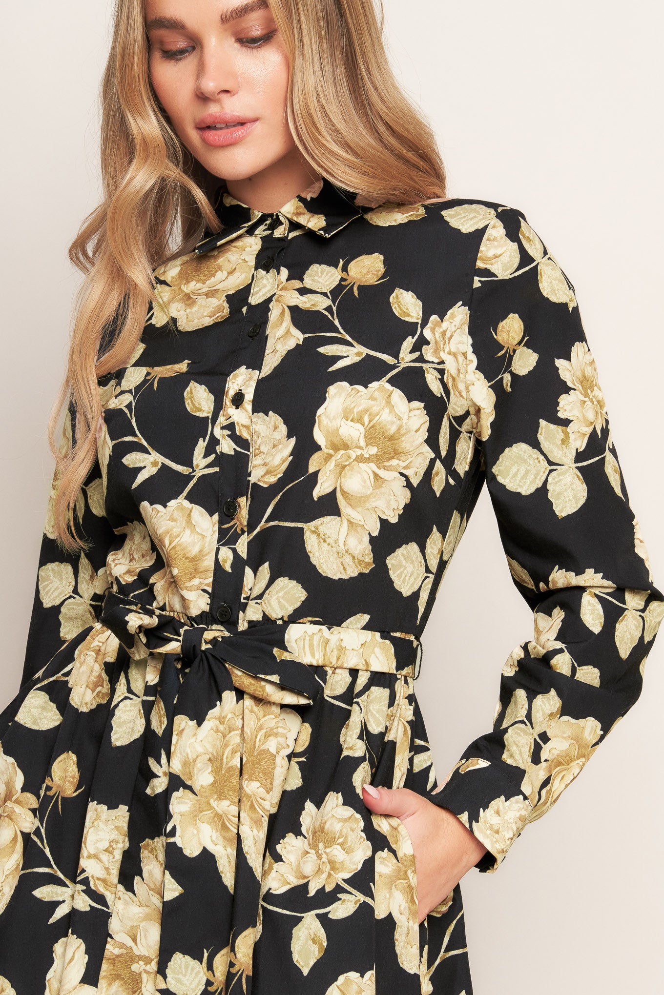 A printed woven midi dress featuring collar, long sleeve, front button down, self sash and full skirt